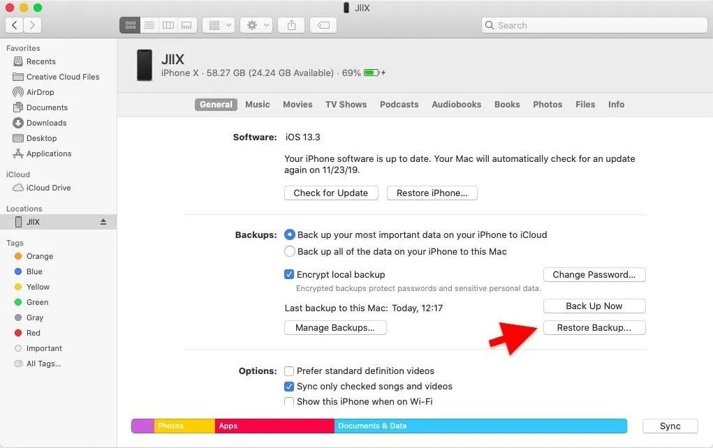 iPhone backup settings screen on a computer, highlighting the 'Restore Backup' option.