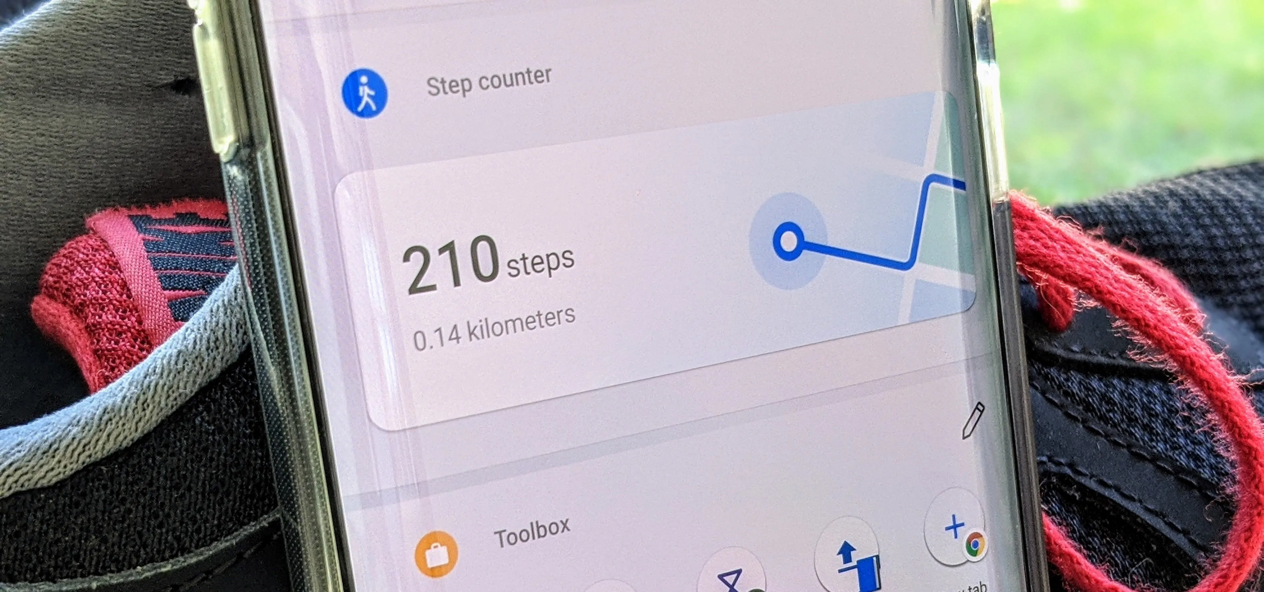 Fitness tracking app displaying 210 steps recorded.