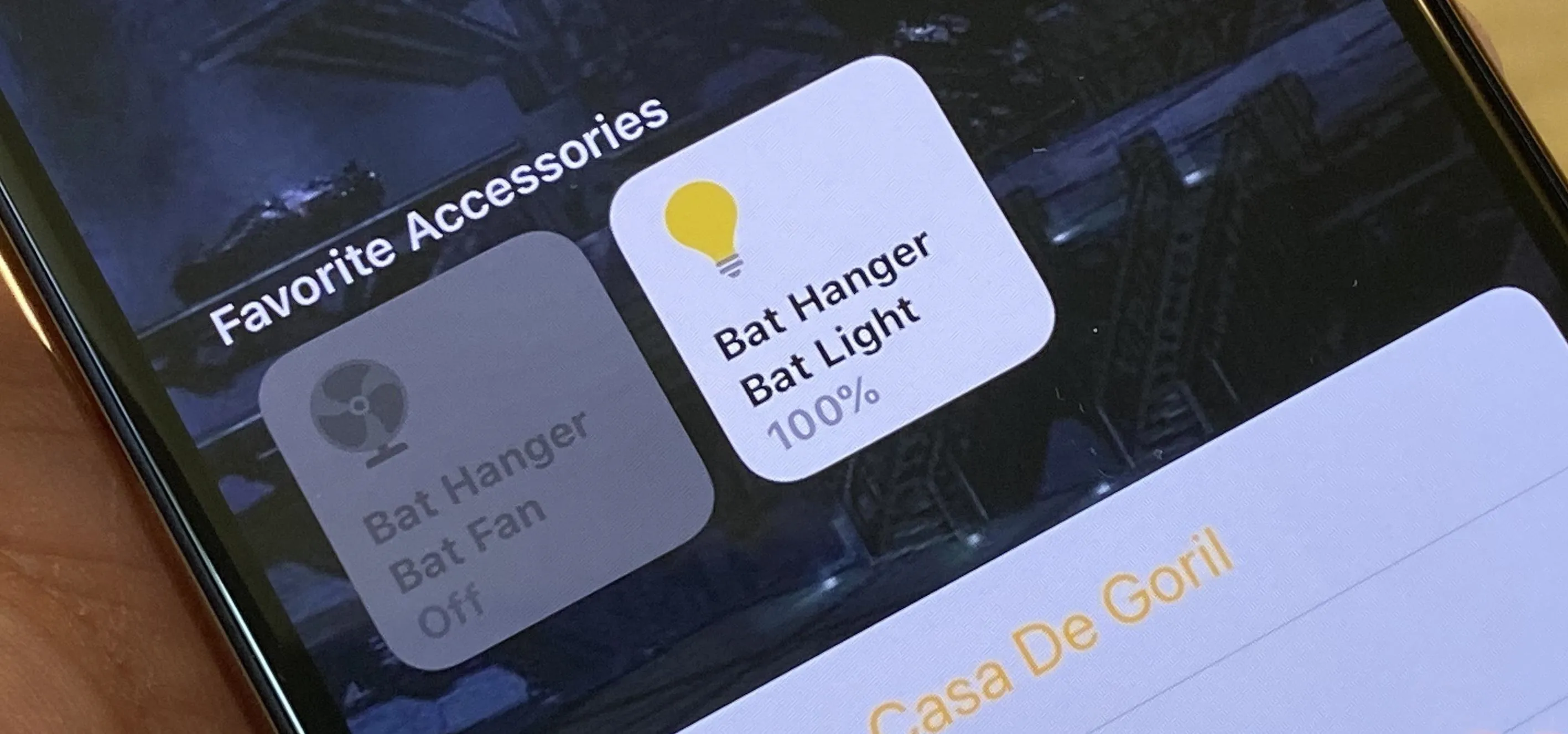 Smartphone screen displaying favorite accessories with a bat hanger and bat light options.