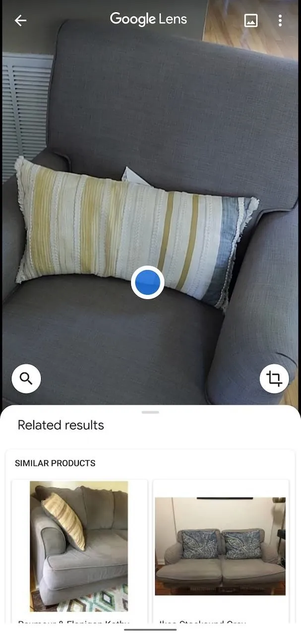 Striped decorative pillow on a gray couch.