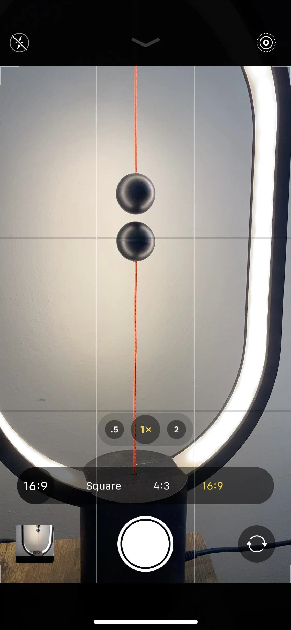 A close-up of a phone camera interface showing a reflection and lighting setup.