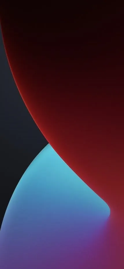 Abstract shapes in red and blue shades on a dark background.