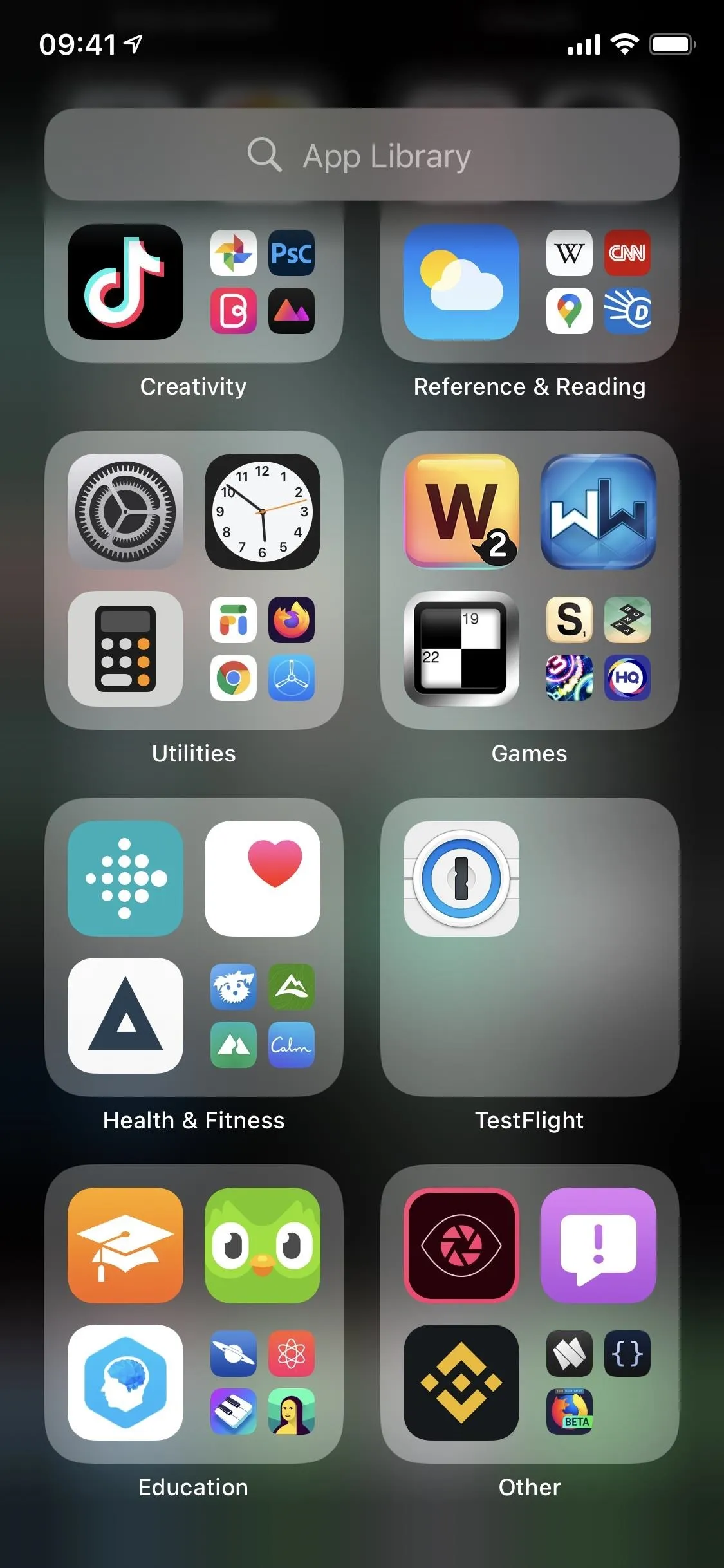 Screenshot of a smartphone home screen displaying various app icons organized in folders.