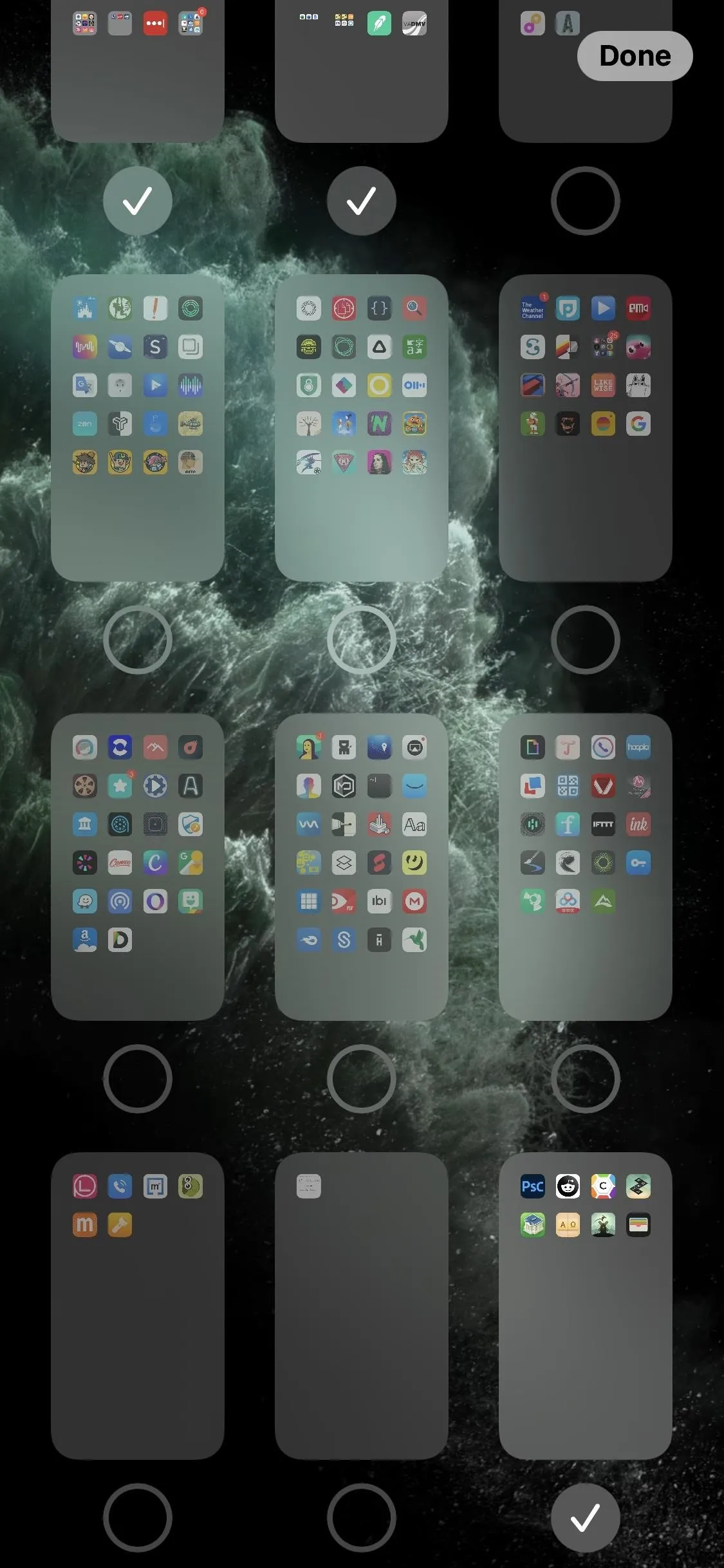 Smartphone home screen displaying multiple app folders and a dark background.