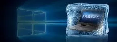Laptop frozen in ice with the word "FREEZE" displayed on the screen.