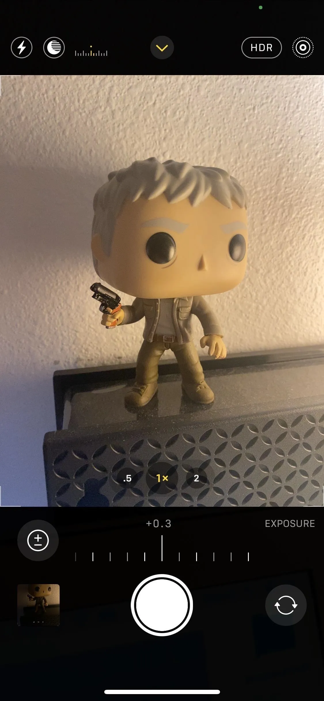 Funko Pop figurine of a character holding a gun.