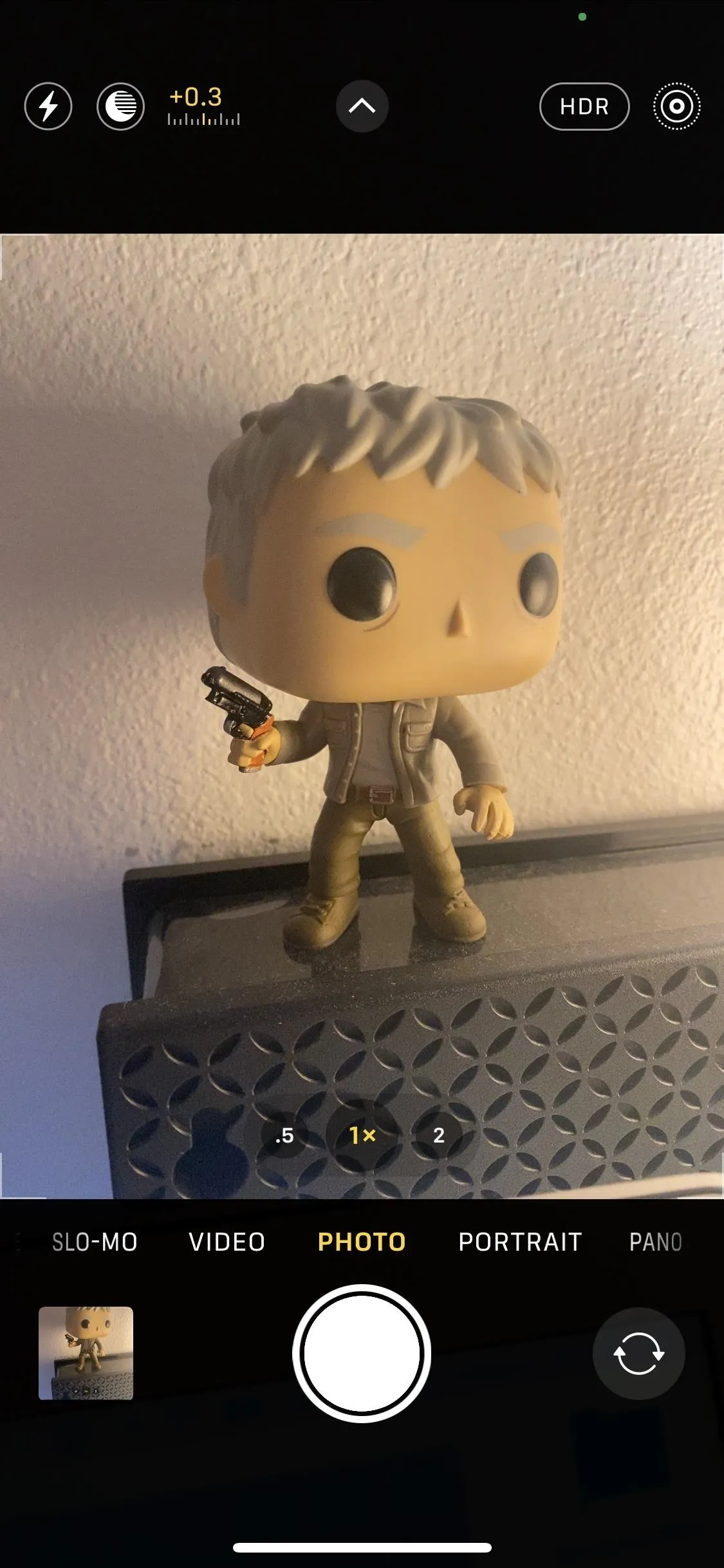 Funko Pop figure of a character holding a gun.