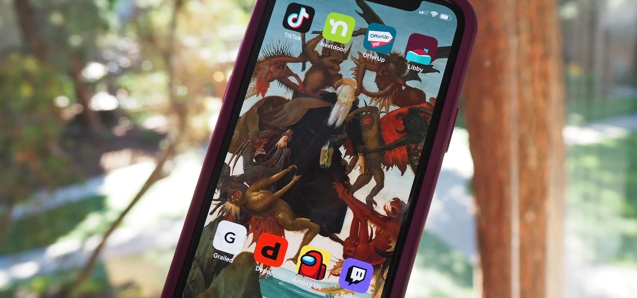 Smartphone displaying various app icons on its home screen.