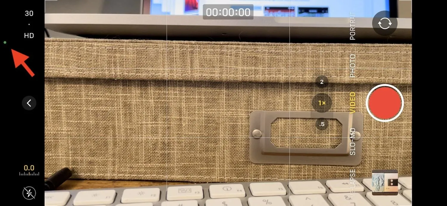 Close-up of a textured storage box with a keyboard in the foreground and a blurred screen in the background.