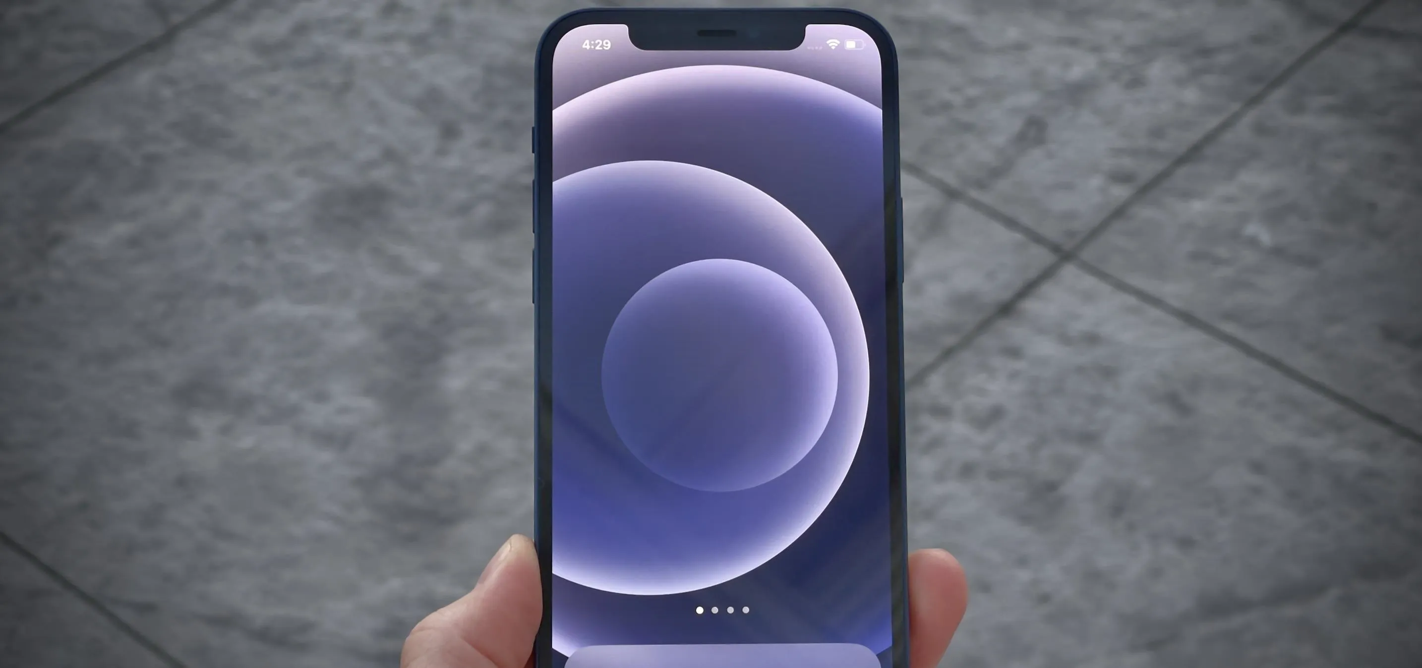 Smartphone displaying a circular abstract wallpaper.