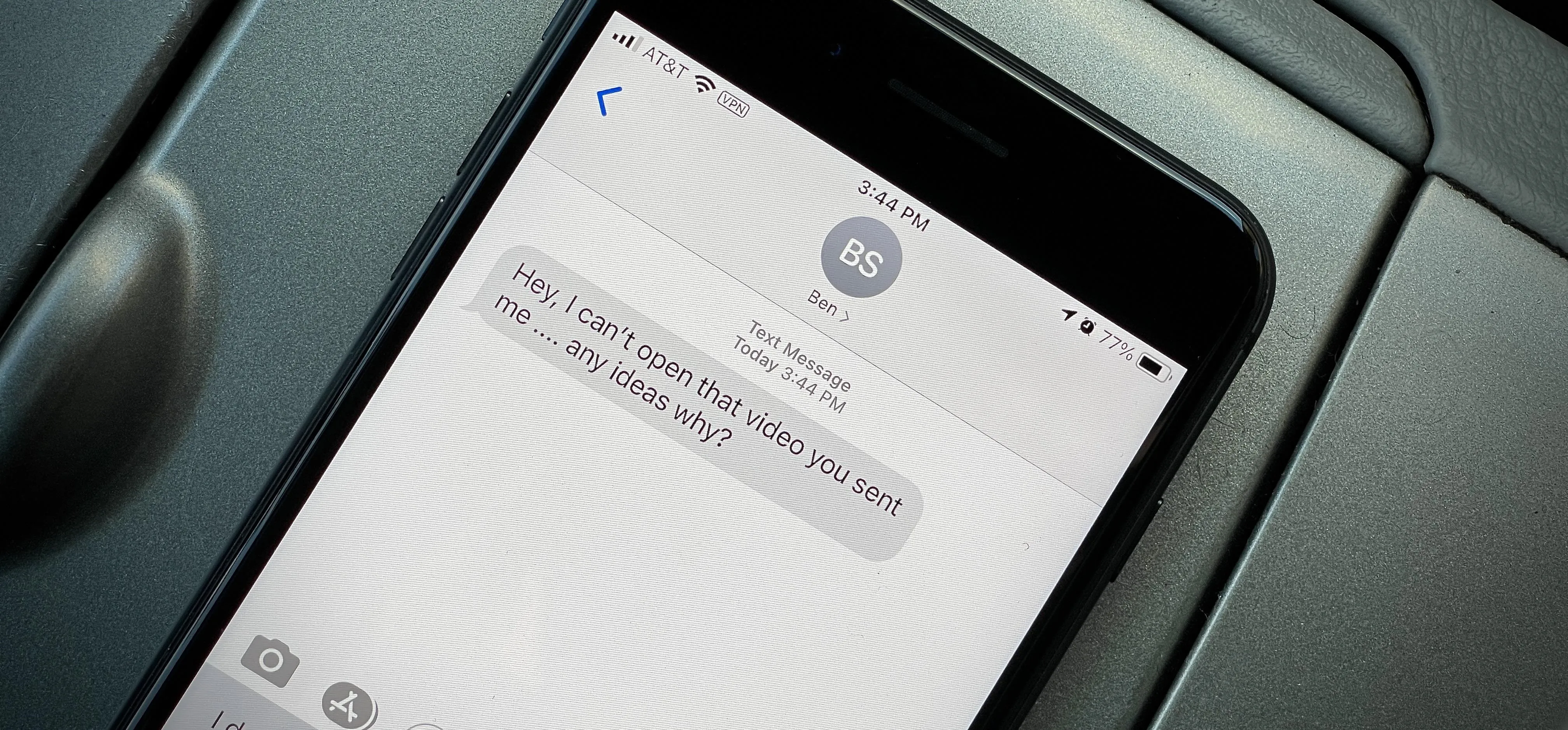 Text message displayed on a smartphone with a blurred background.