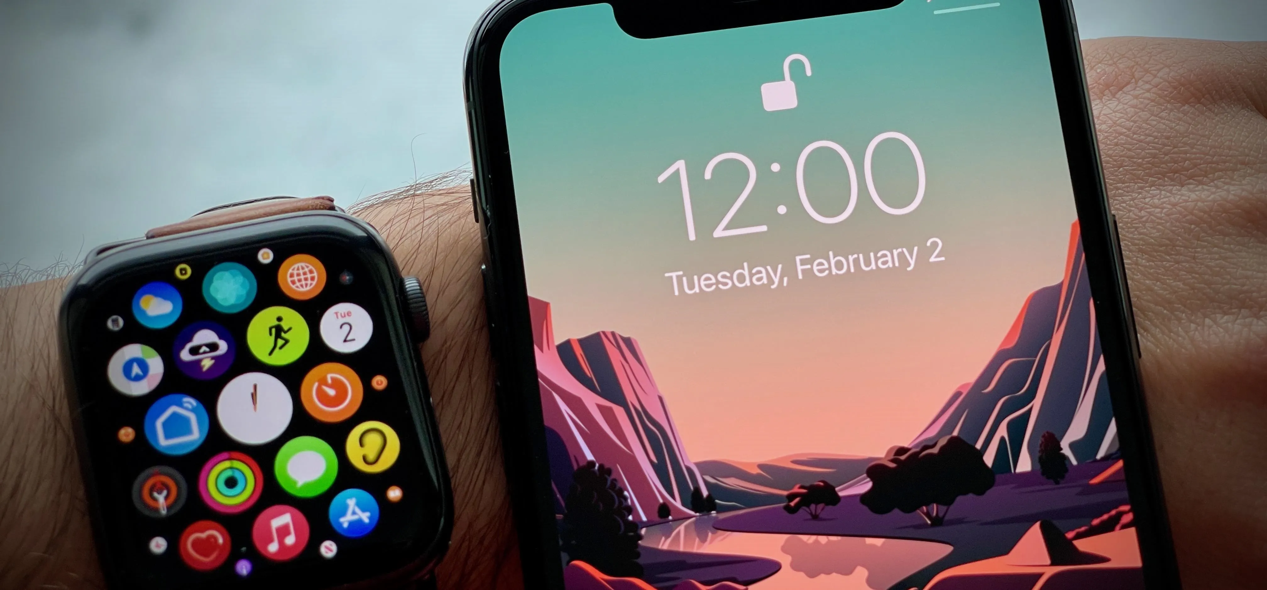 Smartwatch and smartphone displaying time and colorful app icons.