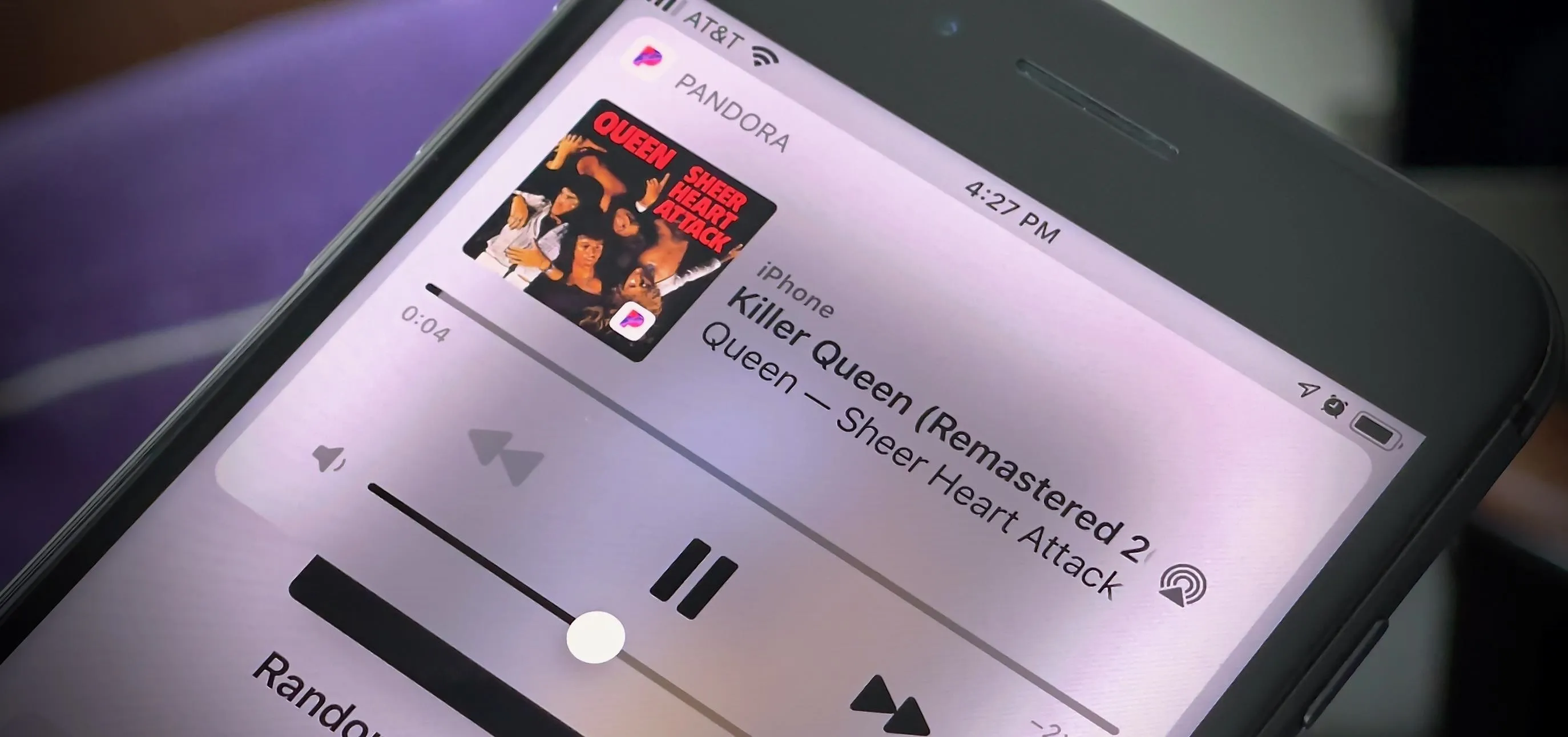 Screenshot of a smartphone displaying a music app playing "Queen: Greatest Hits."