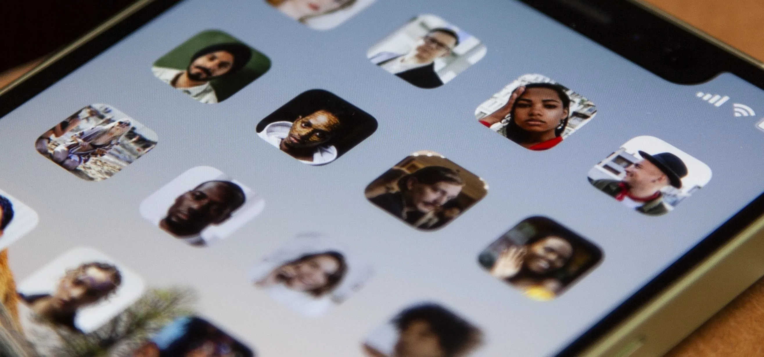 A smartphone screen displaying a grid of profile pictures.