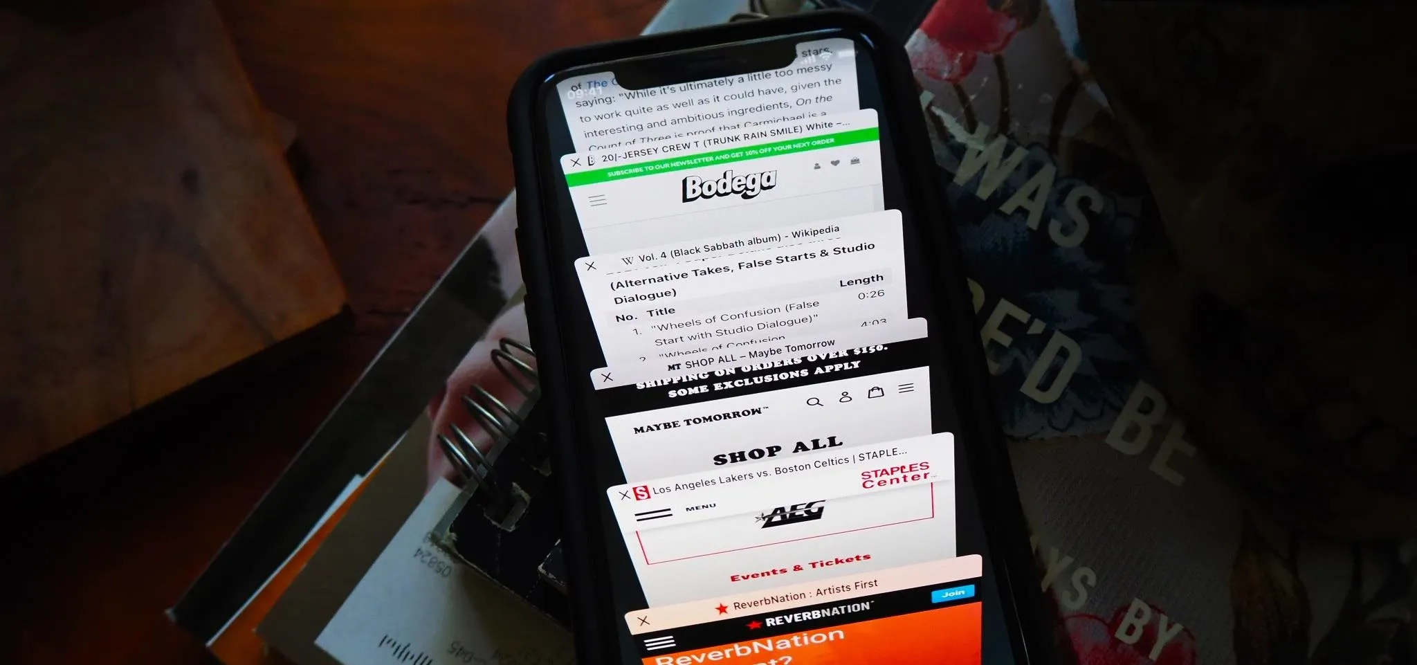 A smartphone displaying multiple open web pages.