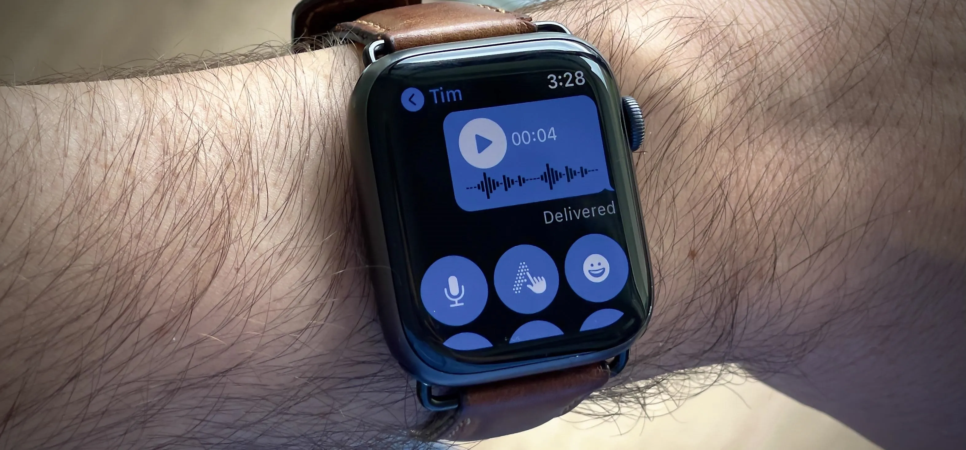 Smartwatch in a sleek white box on a wooden surface.