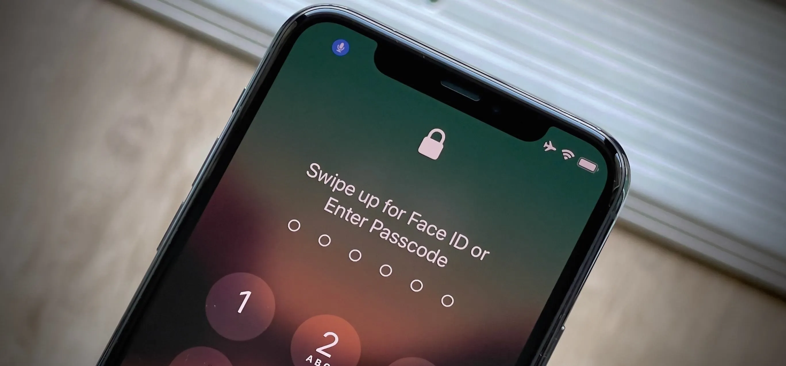 Phone screen displaying a locked interface with options for Face ID or passcode entry.