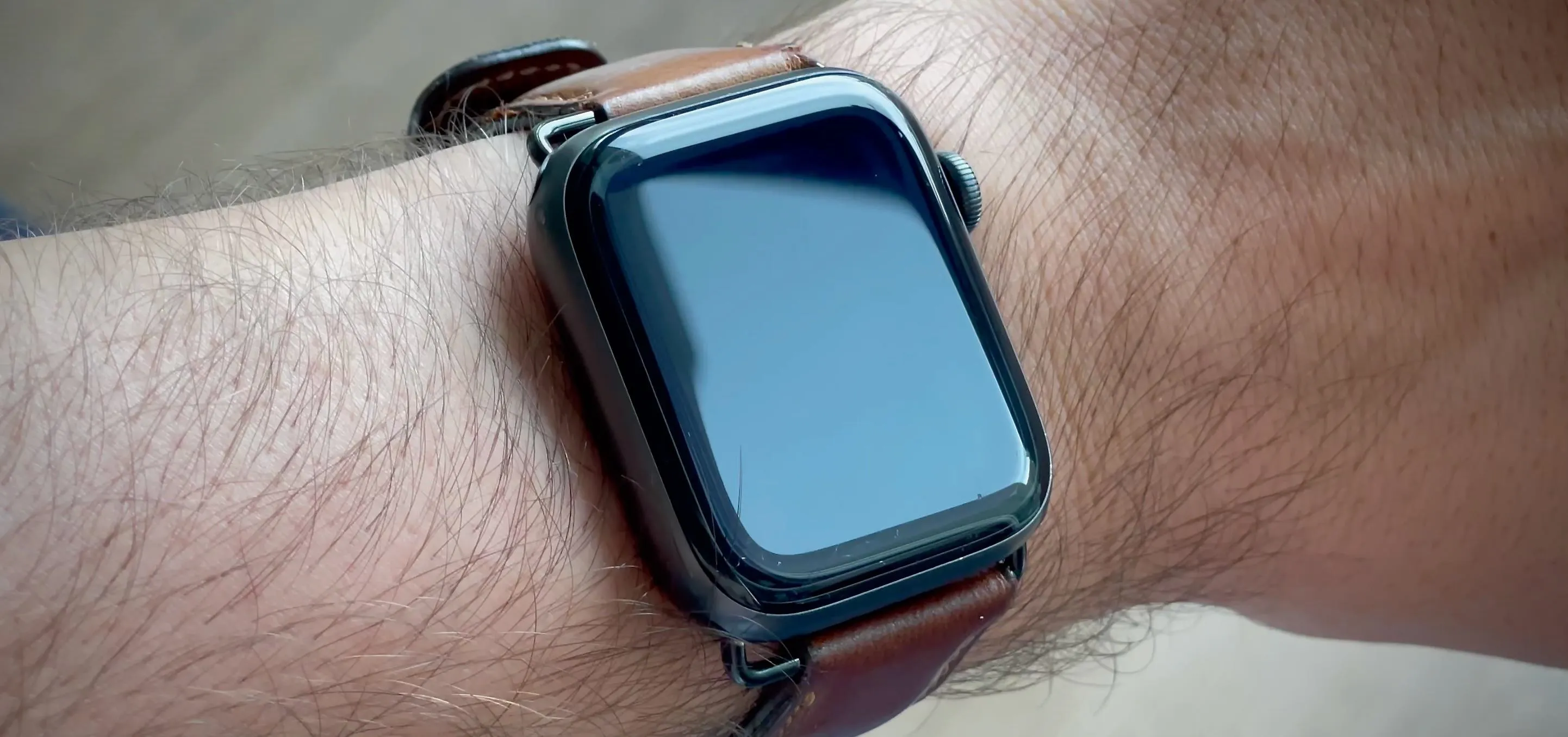 Smartwatch displaying a smiley face on its screen.