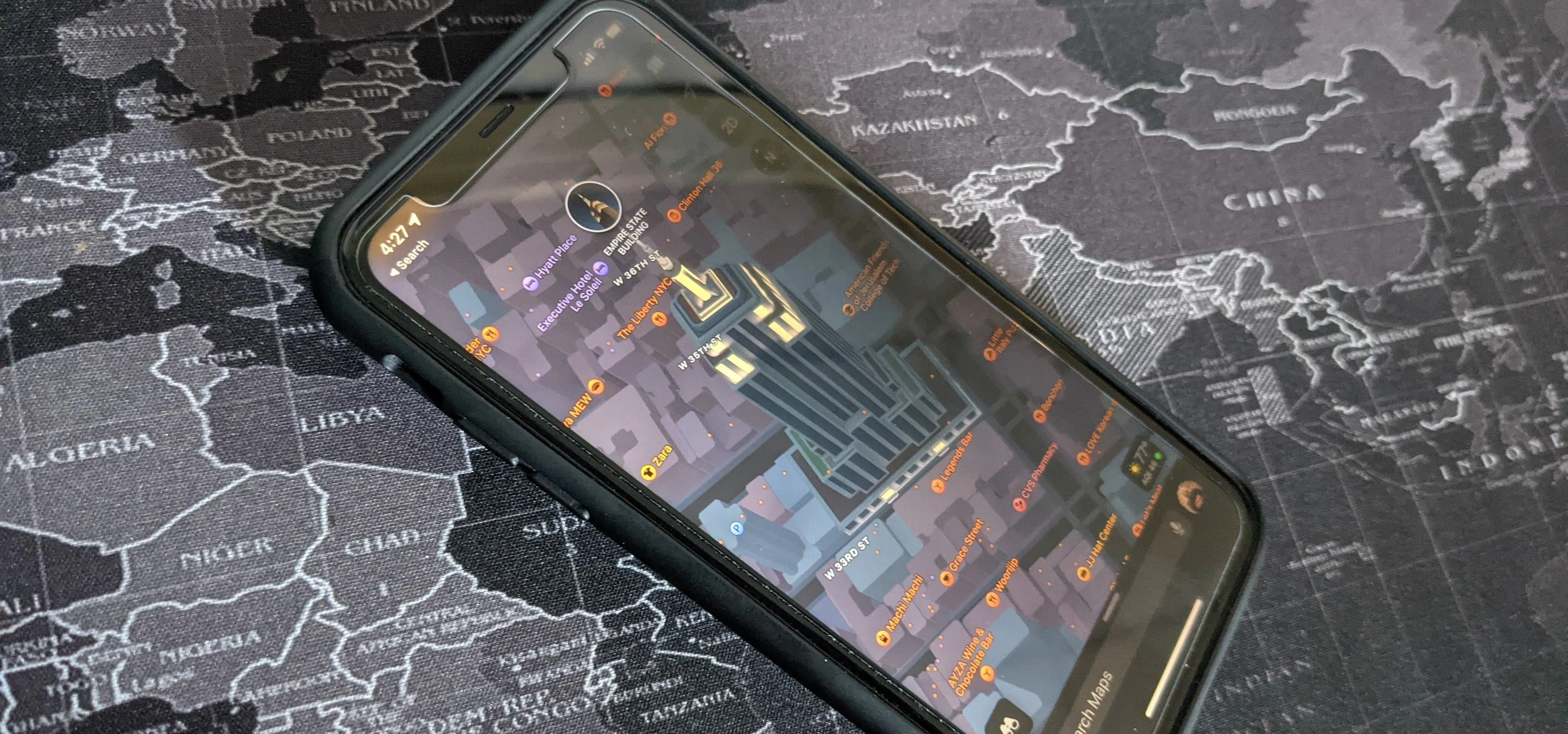 Smartphone displaying a game on a textured map background.