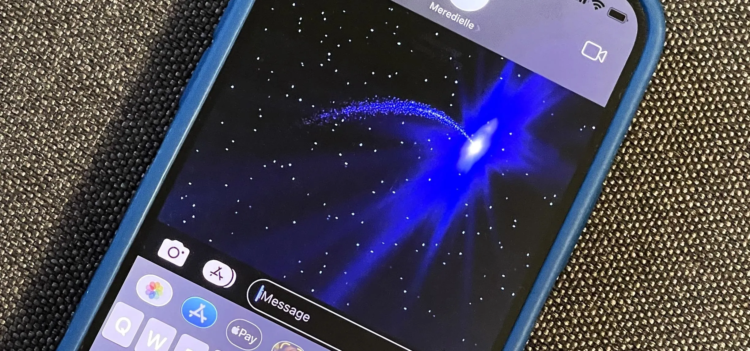 Blue abstract cosmic background displayed on a smartphone.