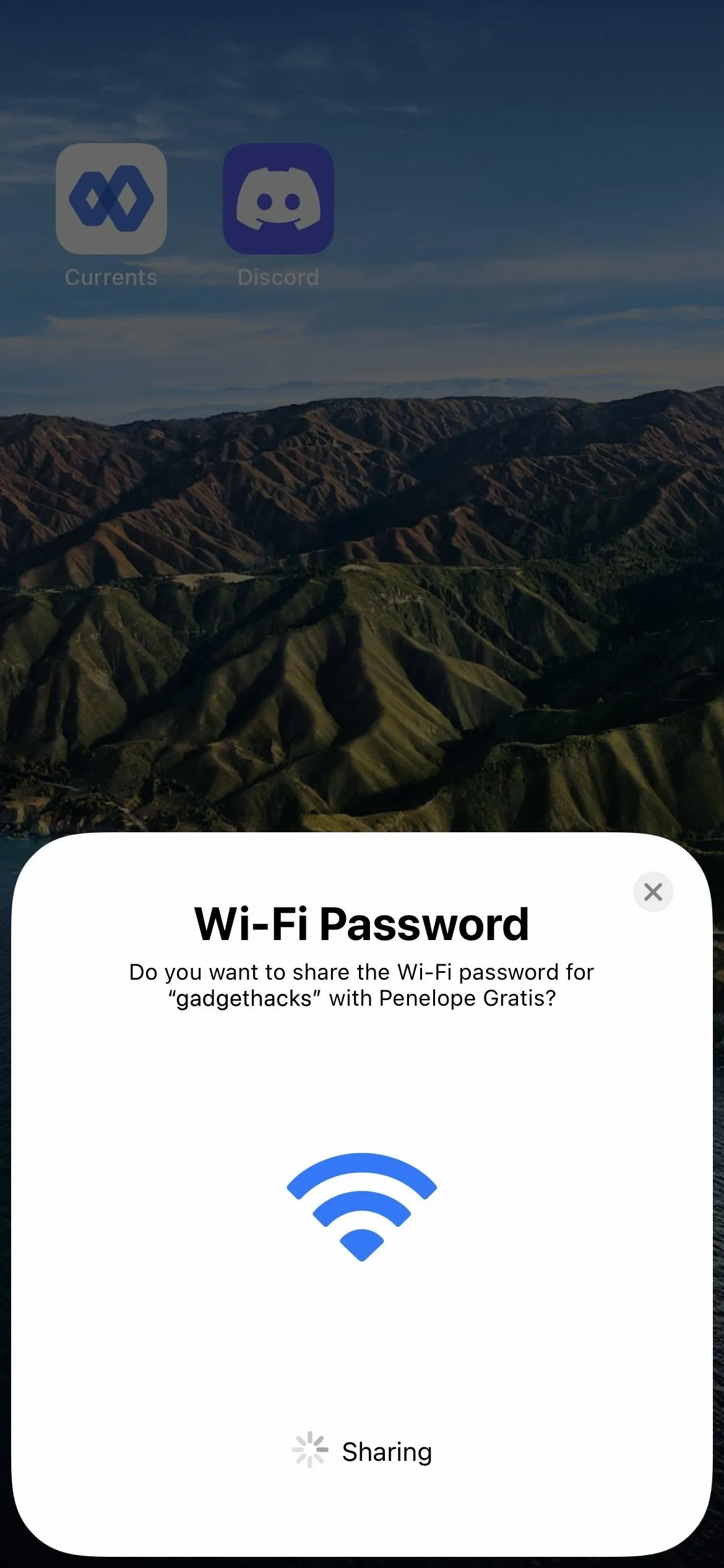 Wi-Fi password sharing prompt on a smartphone screen.