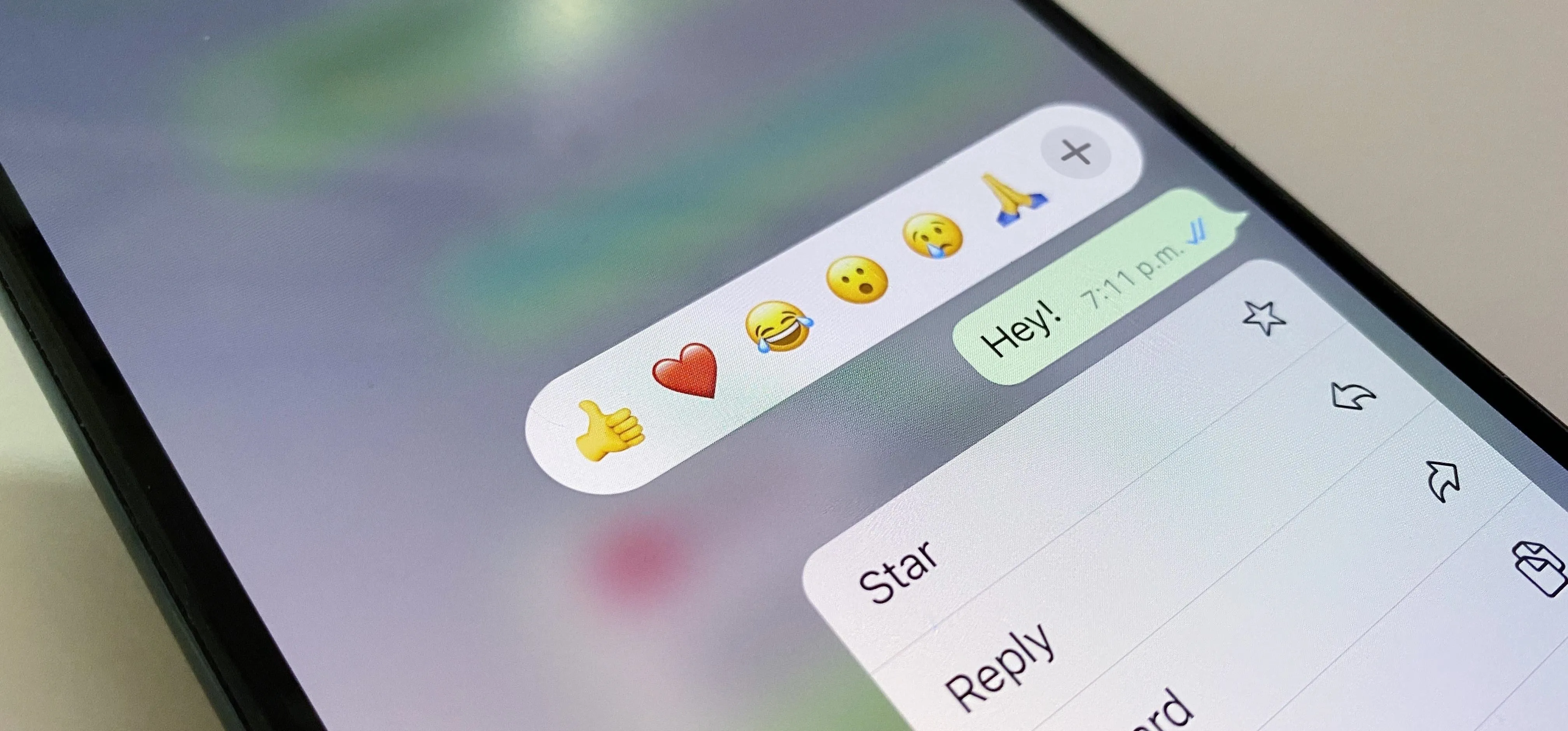 Chat screen displaying emojis and message options on a smartphone.