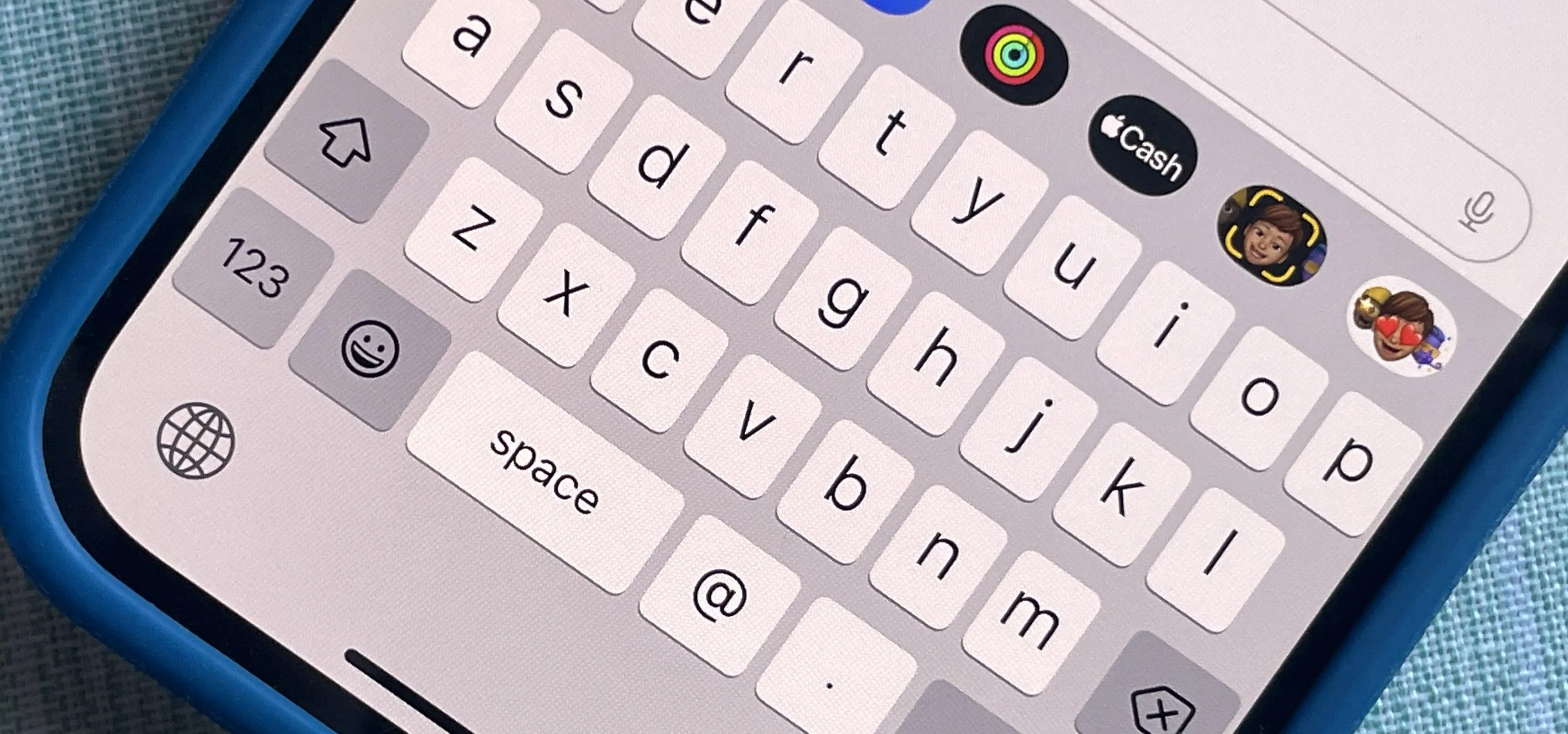 Smartphone keyboard with app icons displayed.