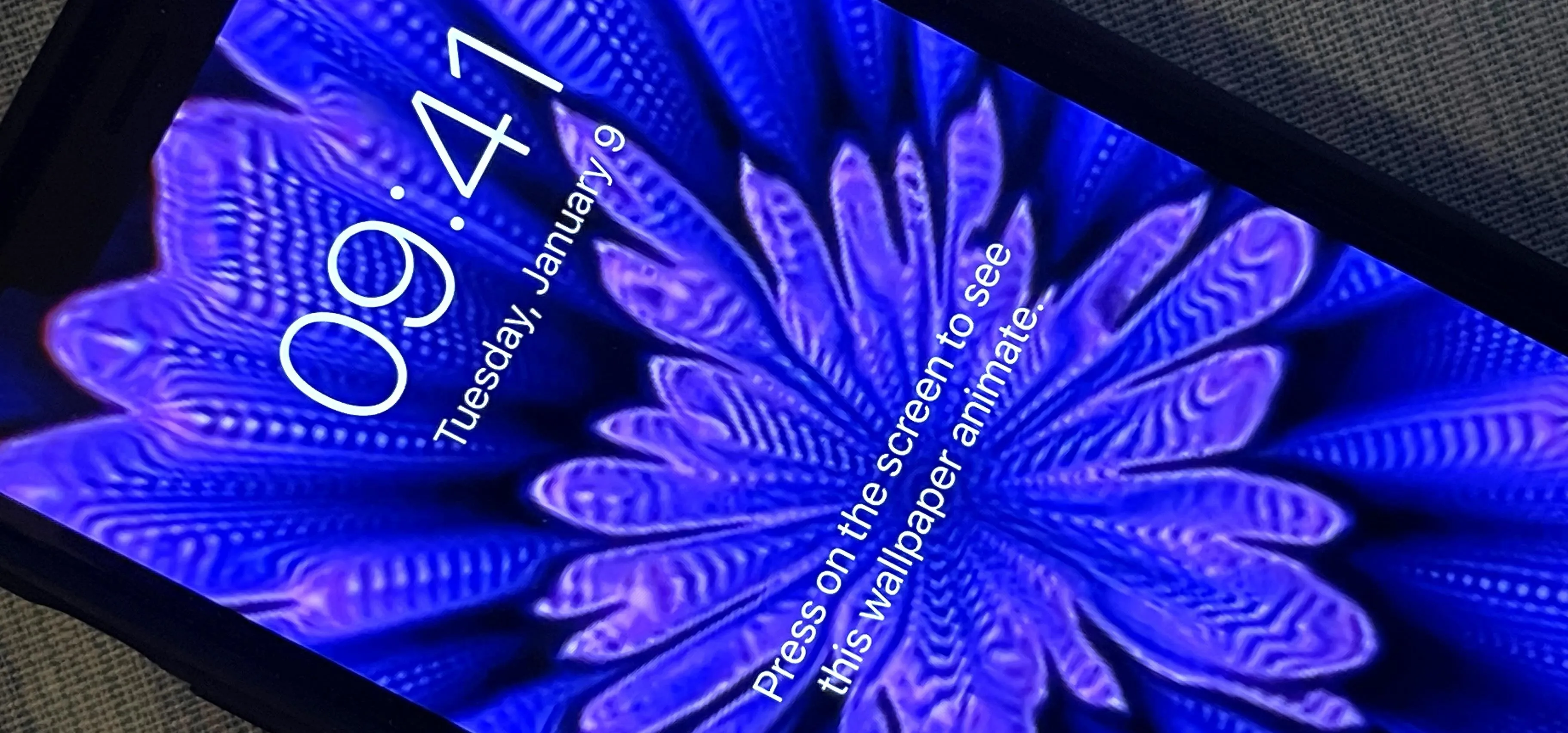 Blue floral design on a smartphone screen displaying the time and date.