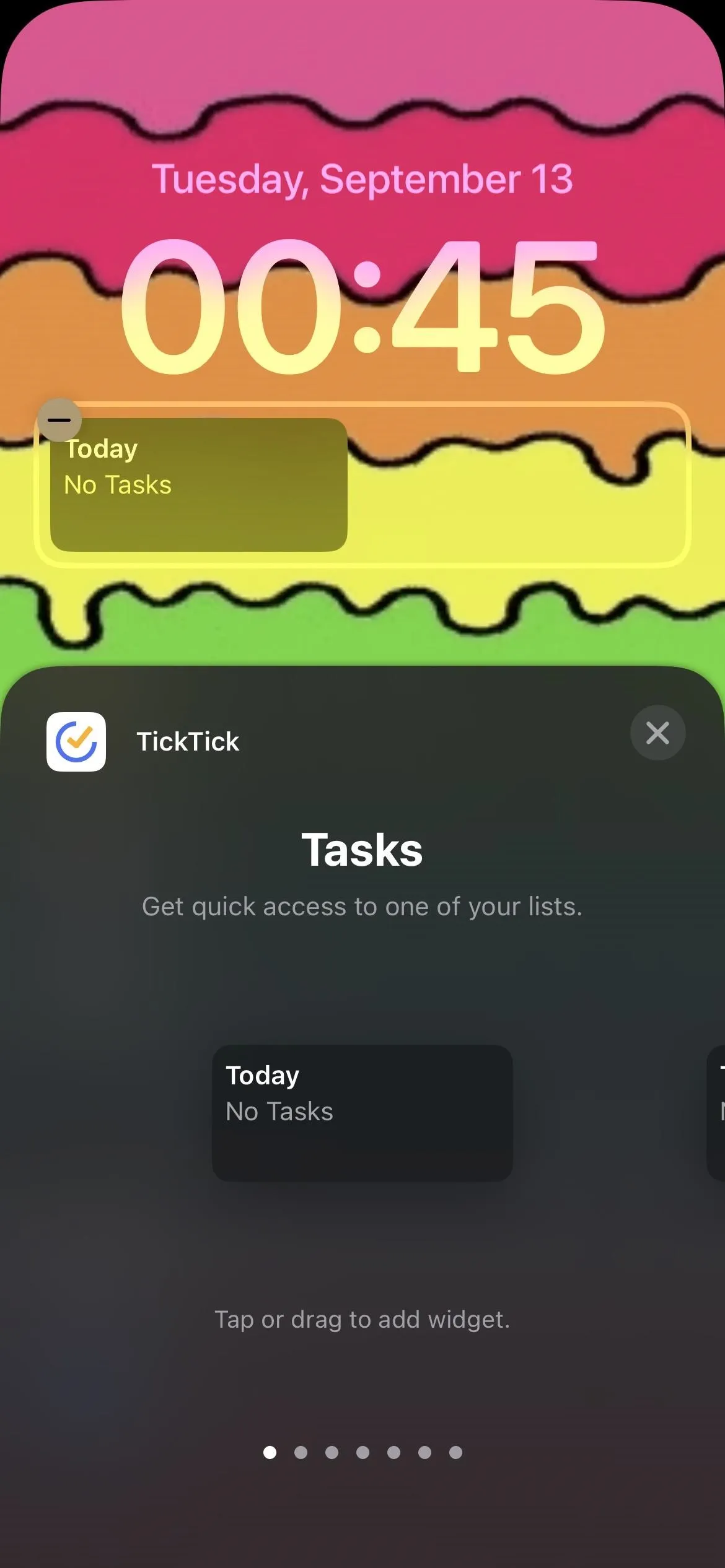 Home screen of a phone displaying a colorful background, time, and task notifications.