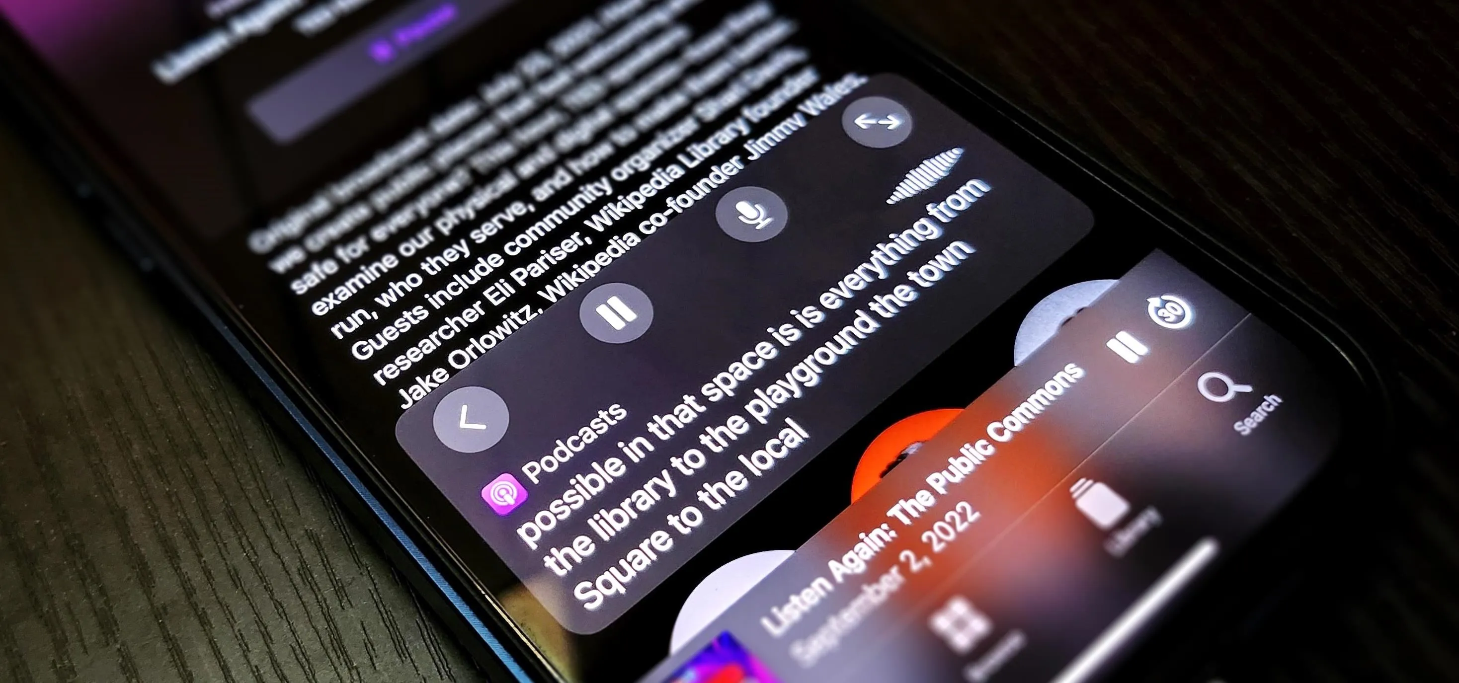 Close-up of a smartphone screen displaying audio playback controls and text content.