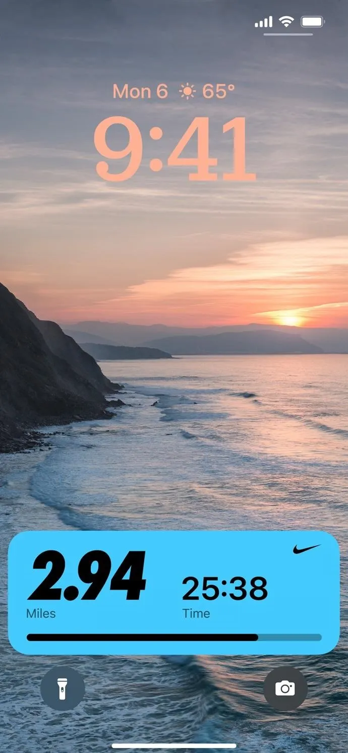 Sunset over the ocean with waves and a cliff, displaying a smartphone lock screen.