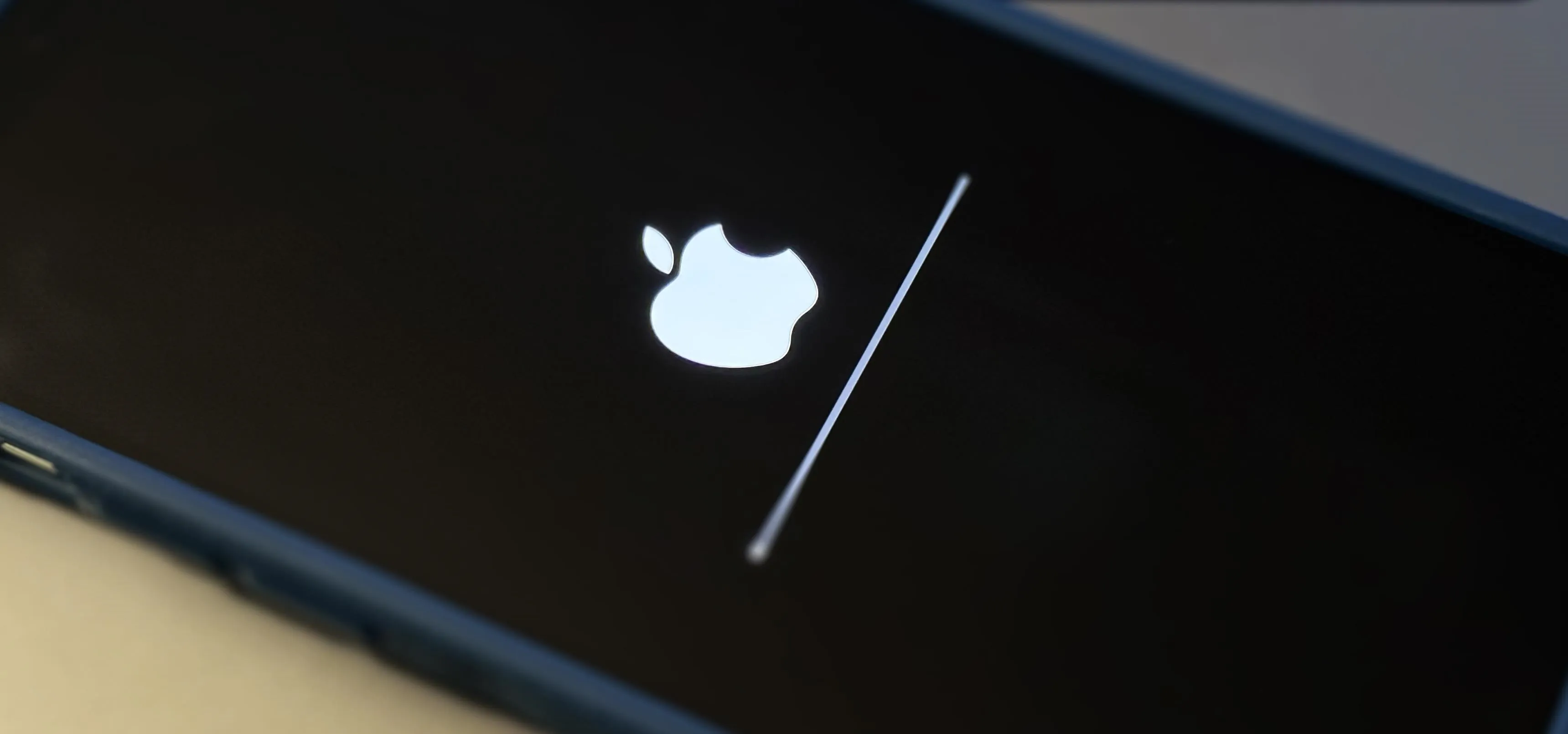 Apple logo on a smartphone screen during a software update.