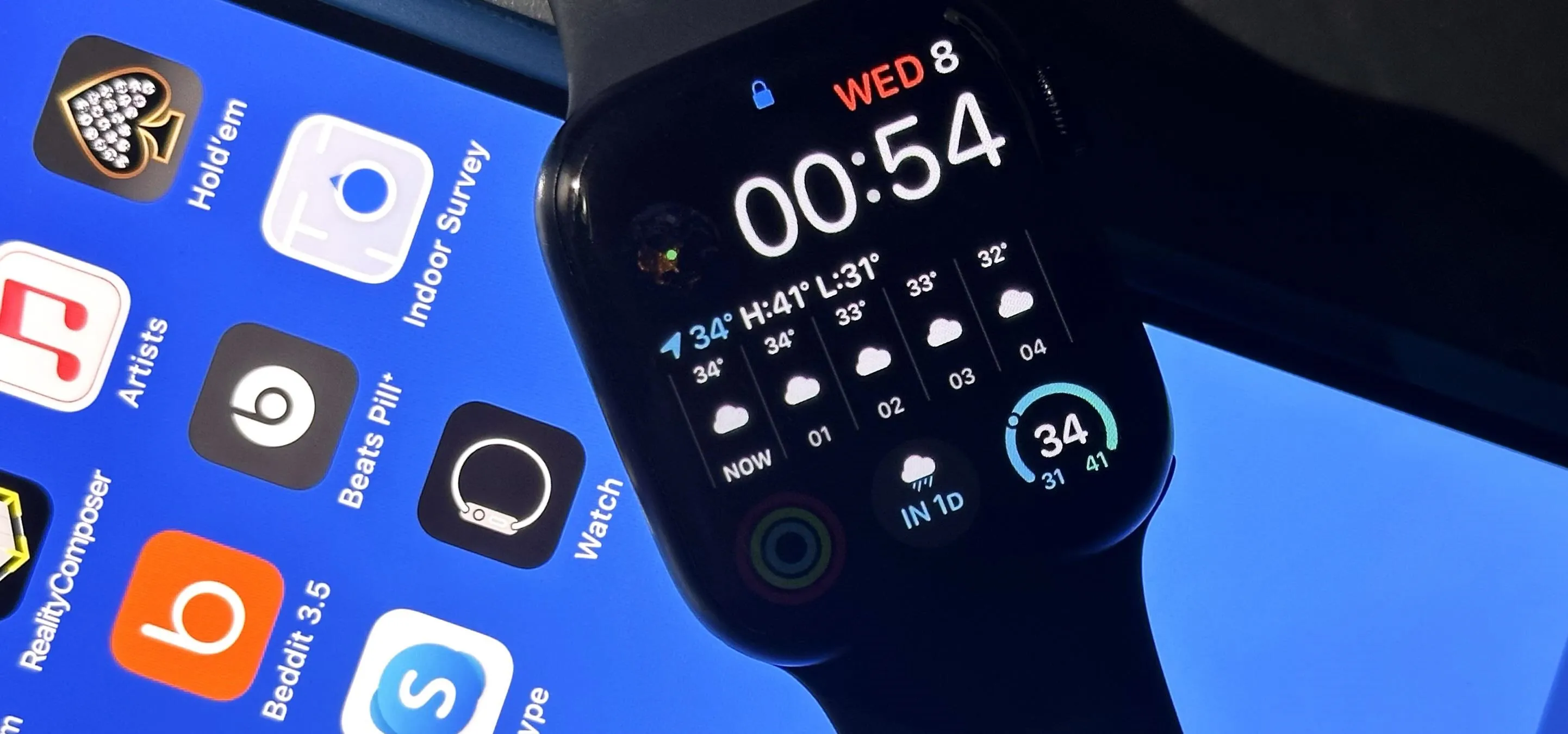 Smartwatch displaying time and weather information with smartphone apps in the background.