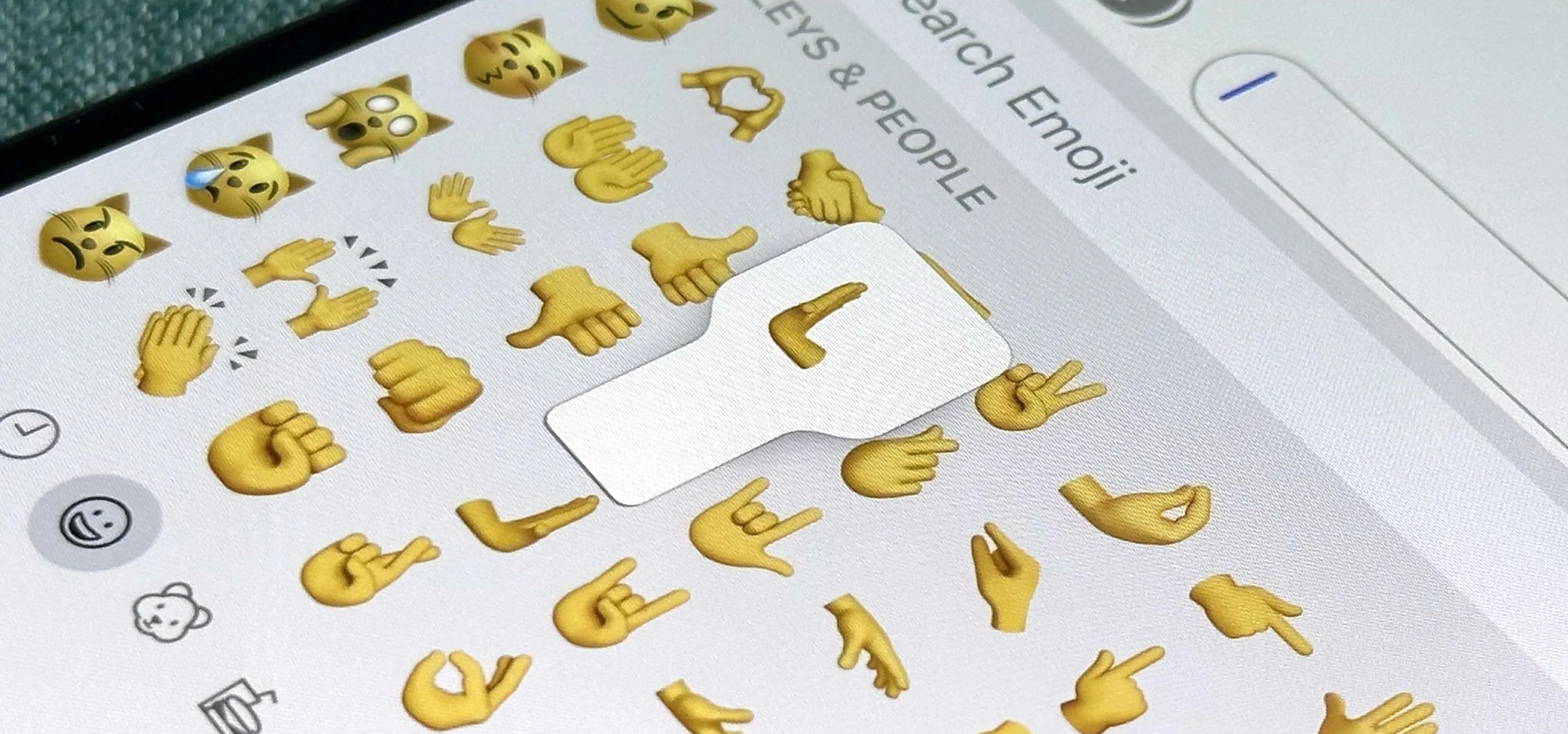 Emoji selection interface featuring various golden hand emojis.