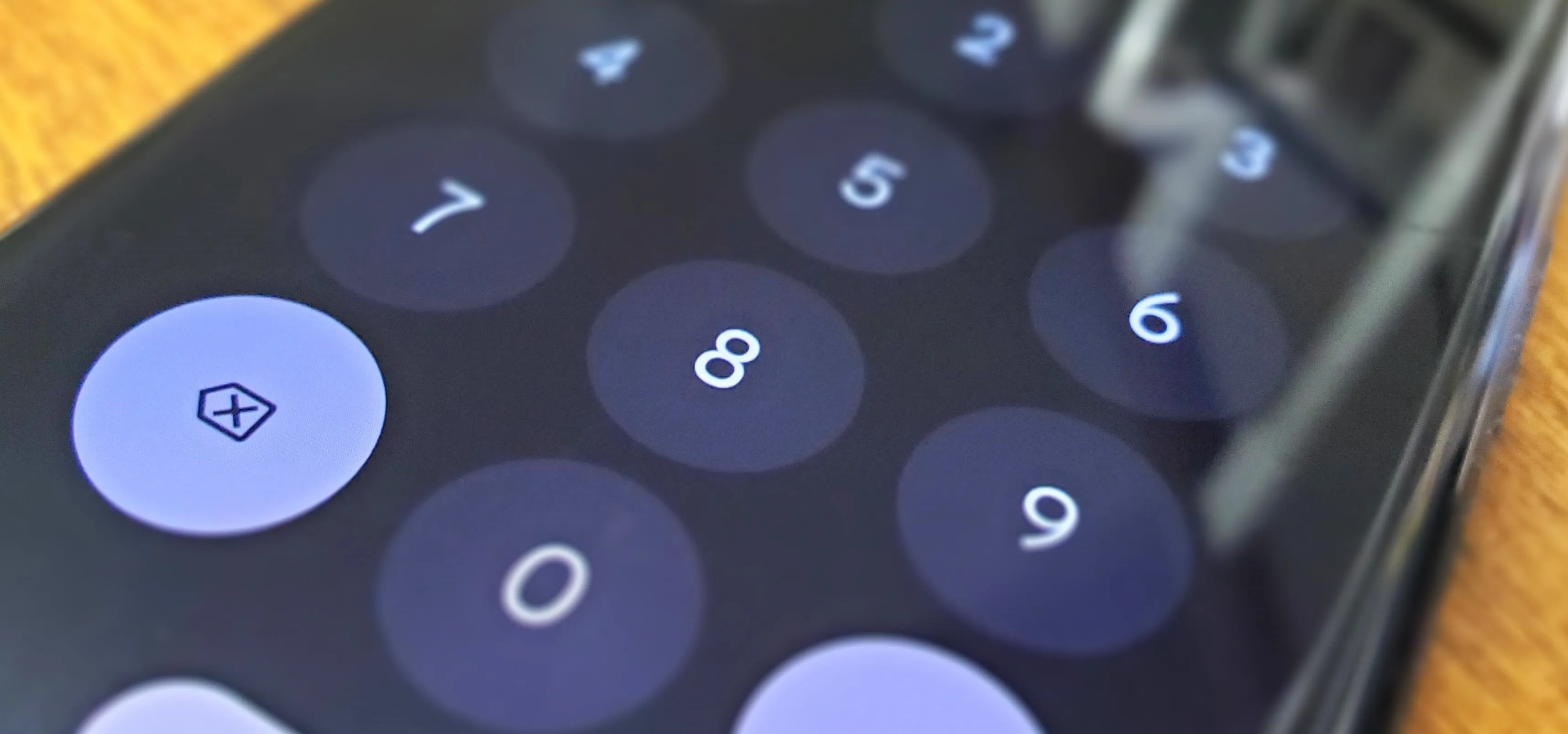 Close-up of a smartphone keypad displaying numbers.