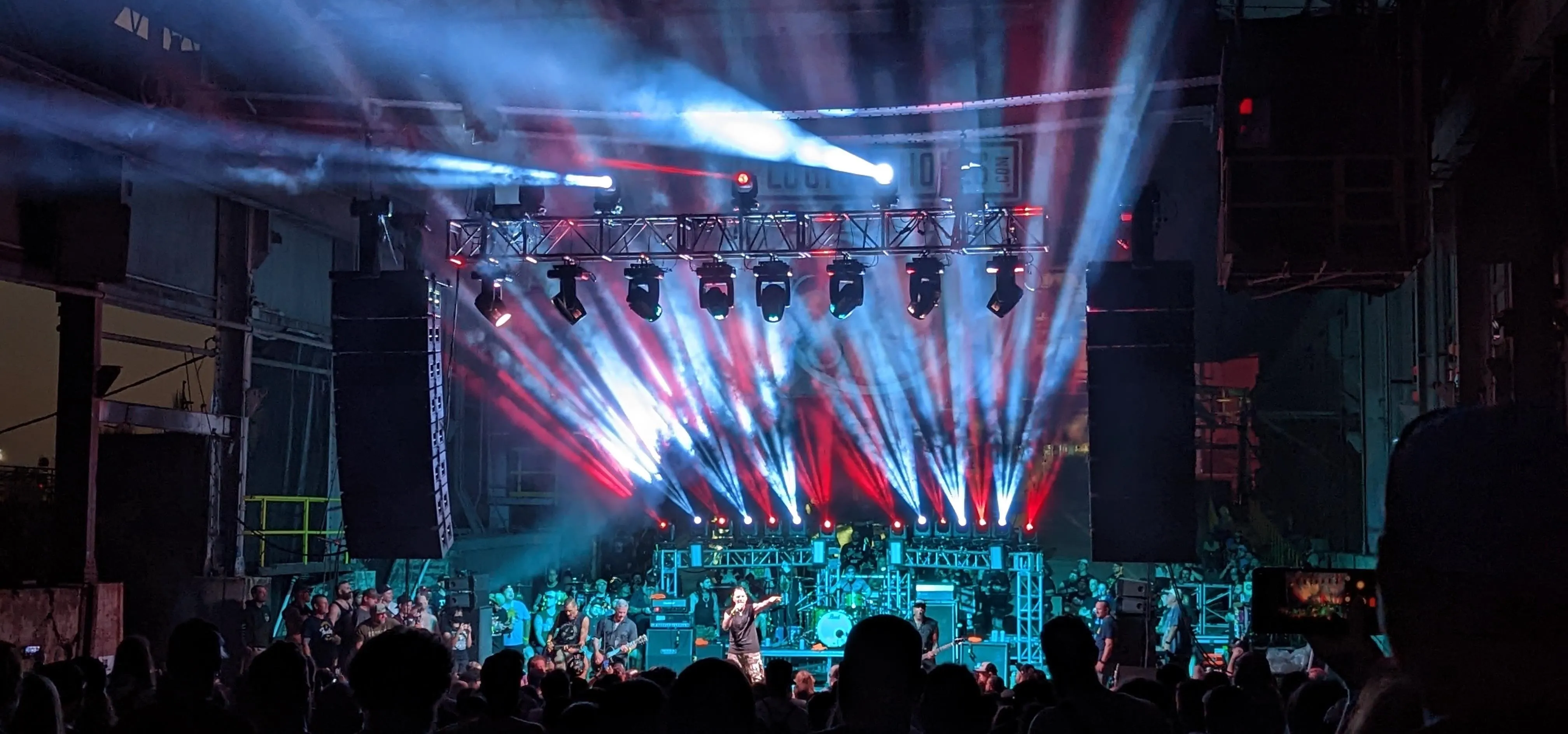 Concert scene with colorful lighting and a crowd enjoying the performance.