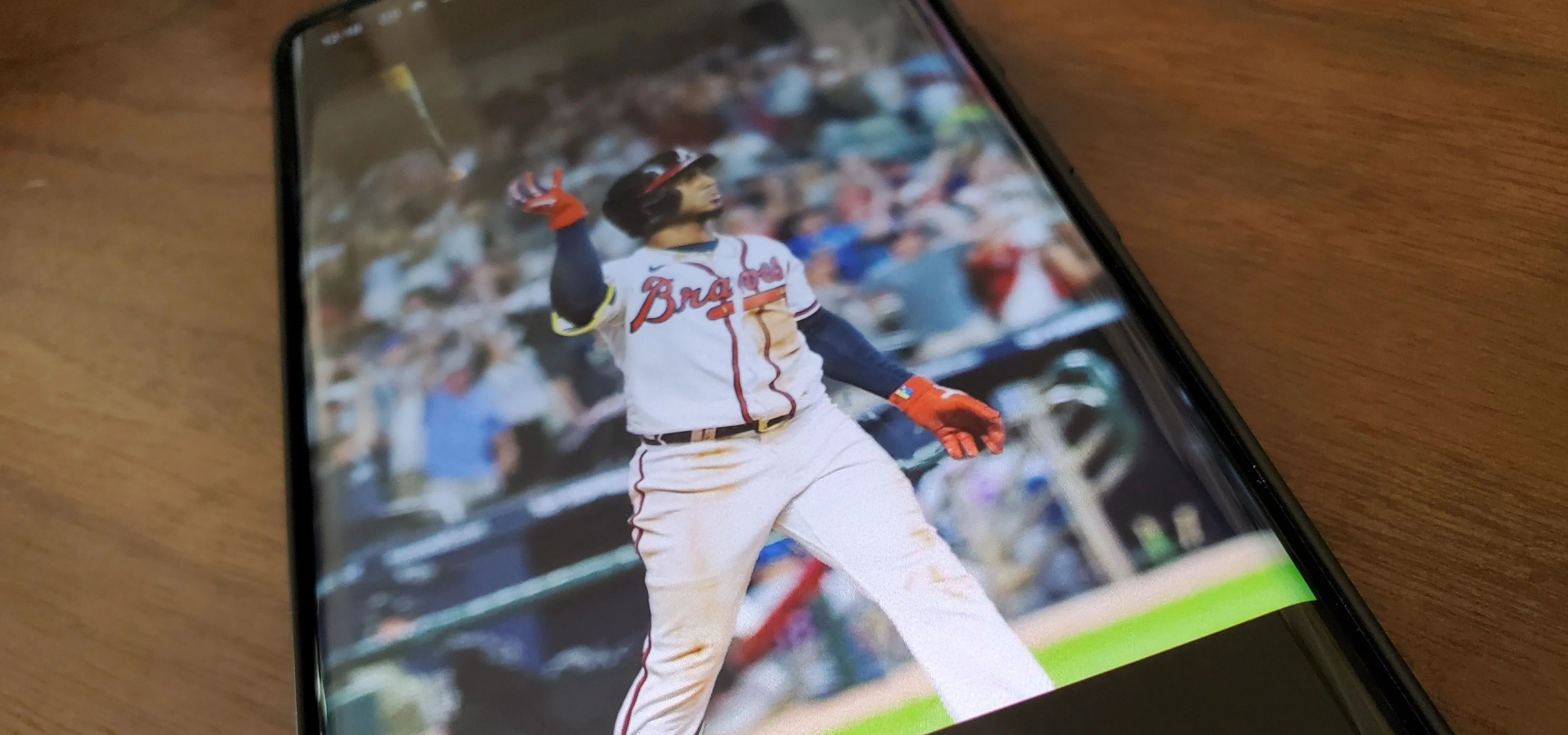 Baseball player in action on a smartphone screen.