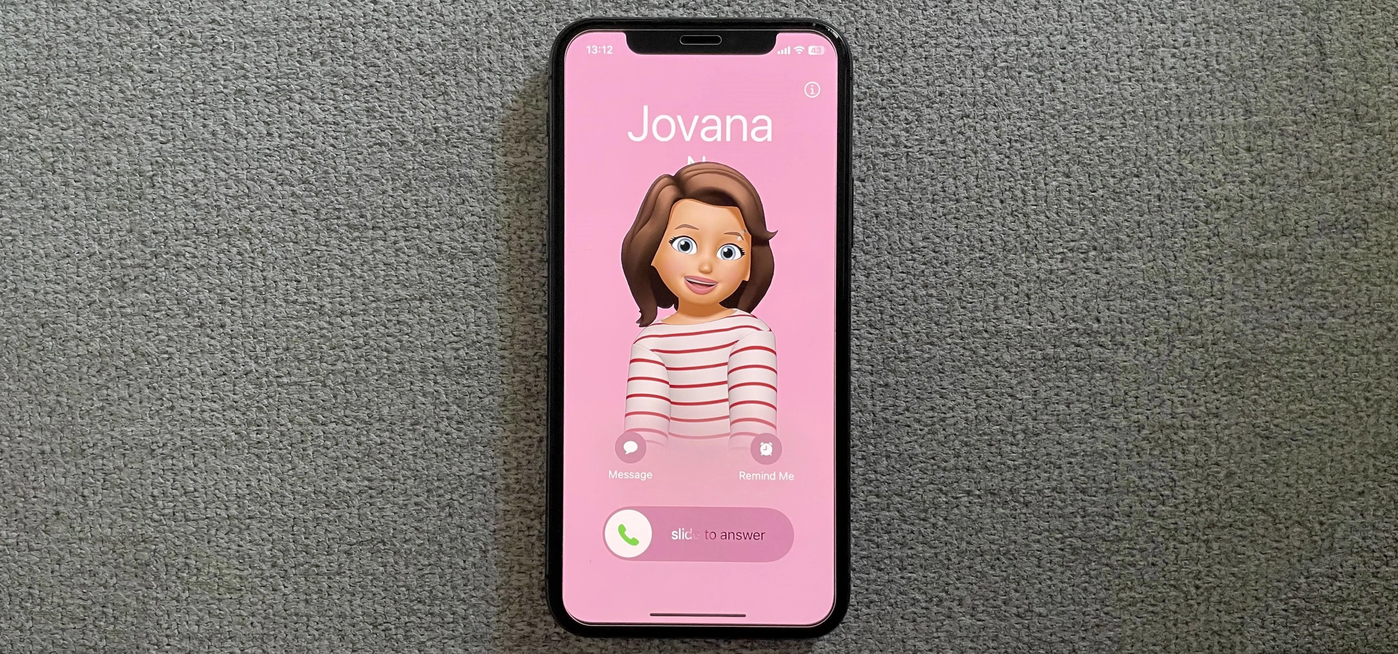 Mobile phone displaying a character avatar on a pink background.