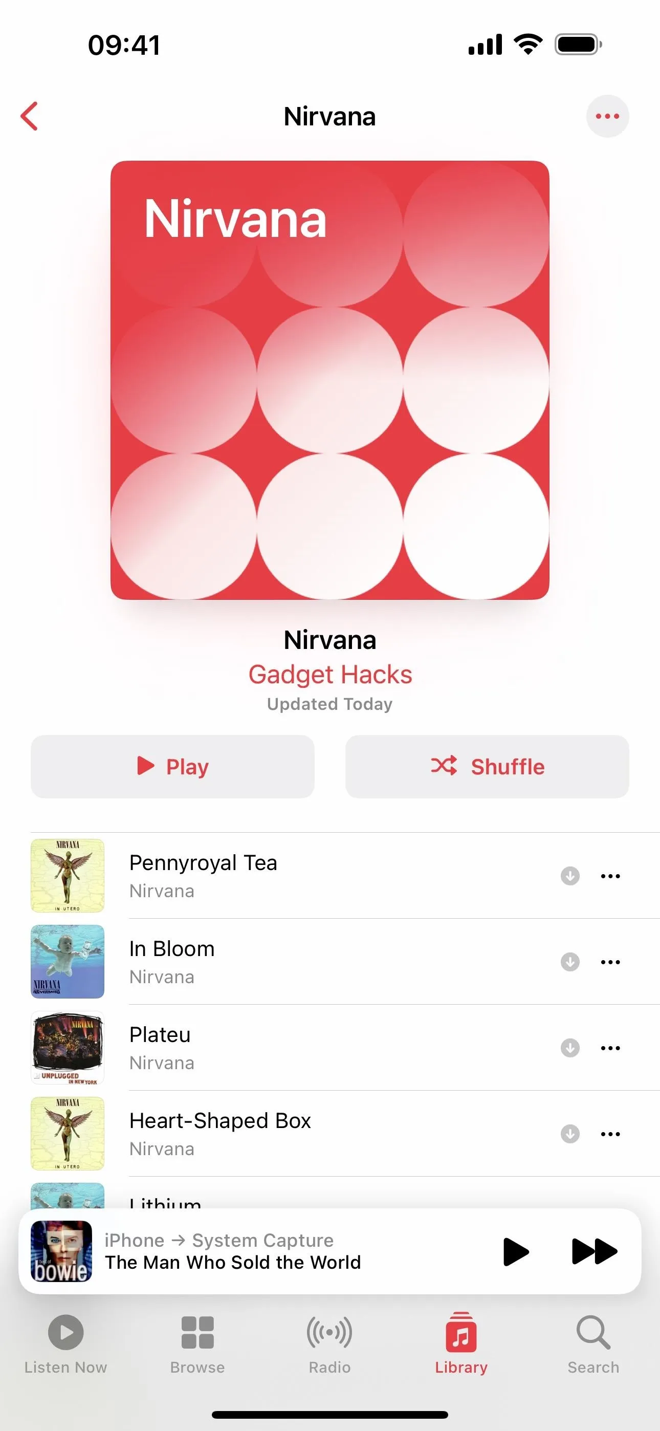 Album cover for "Nirvana" featuring a red background with white circles.