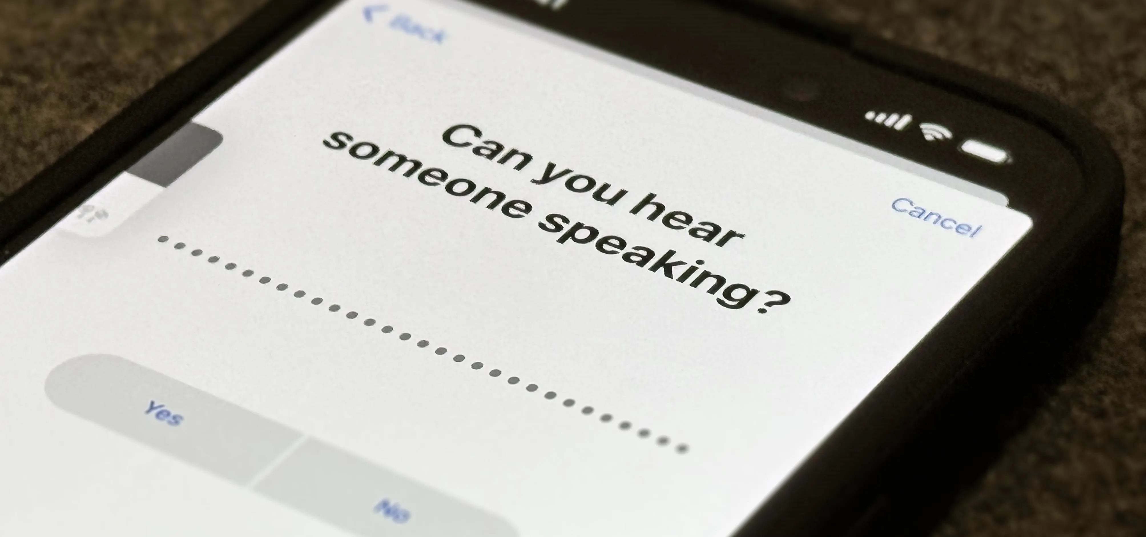 "Mobile device displaying a prompt asking if the user can hear someone speaking."