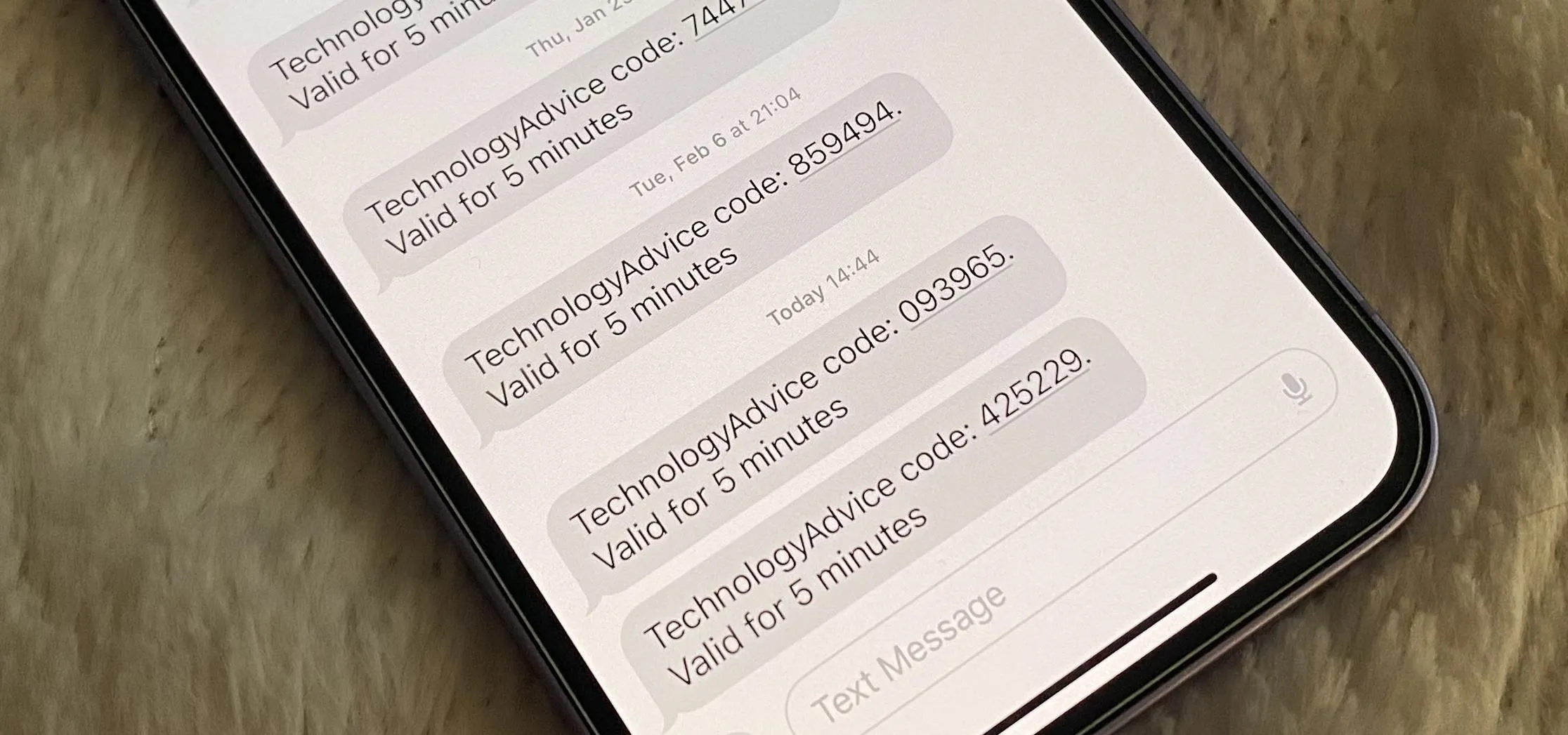 Text messages on a smartphone screen displaying technical codes and expiration notifications.