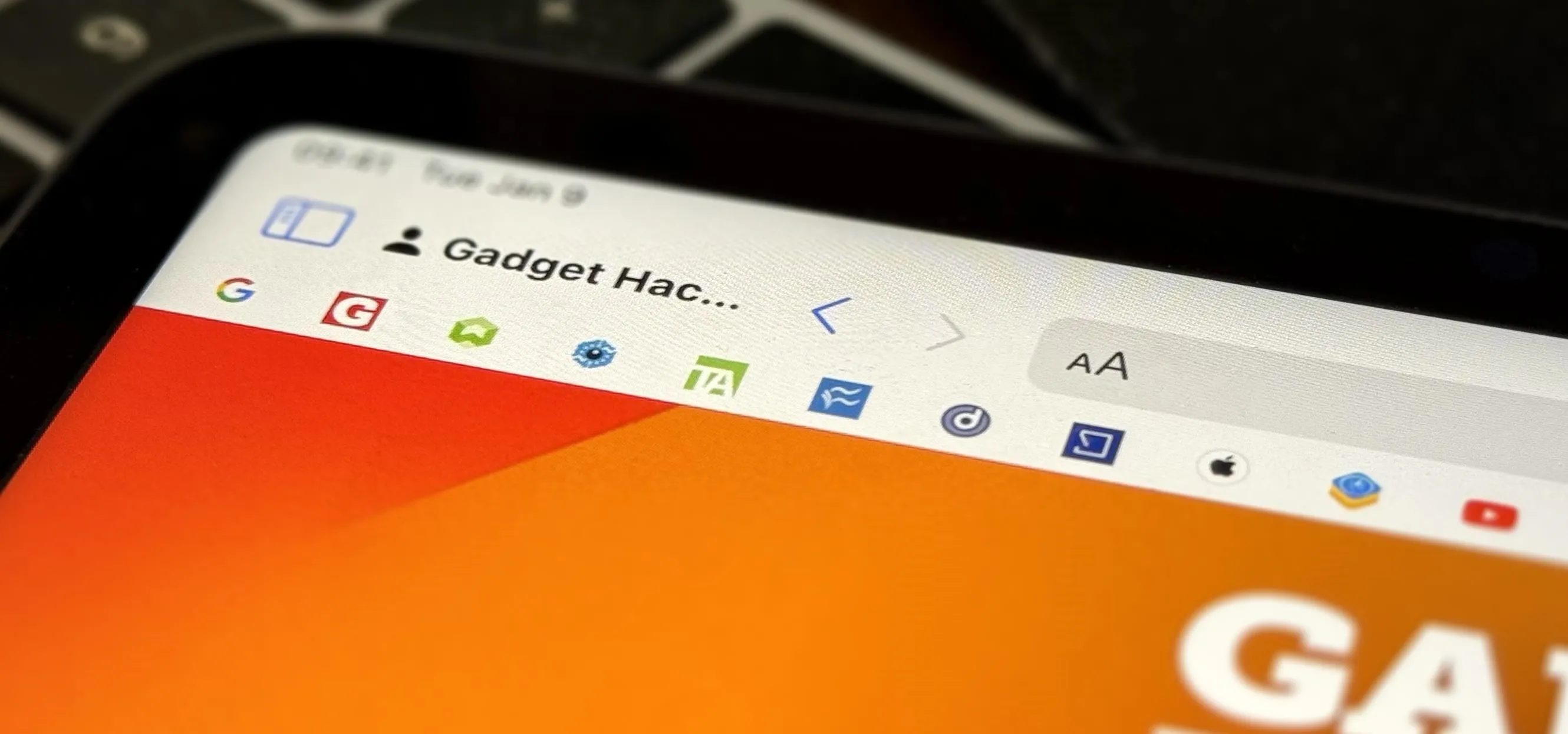 Close-up of a tablet screen showing a web browser interface with a gradient orange background.