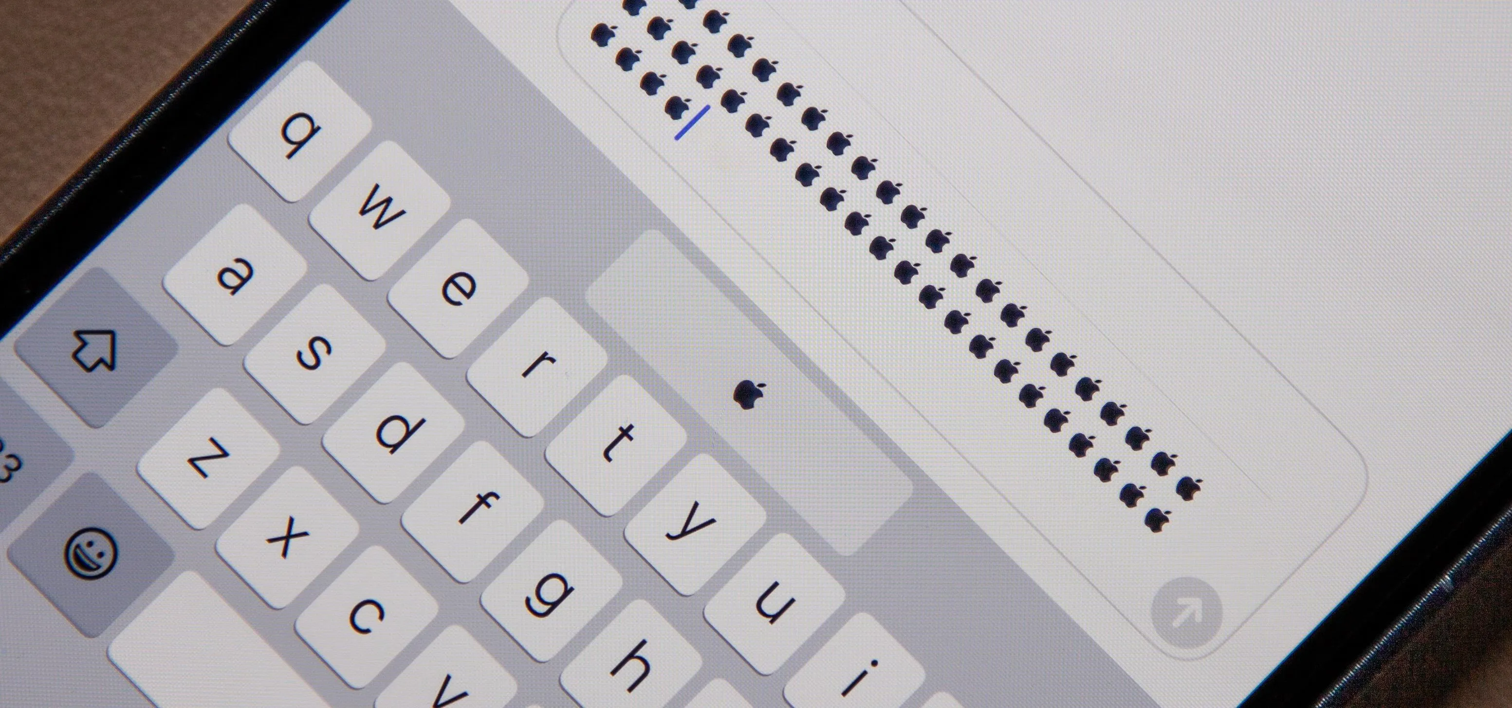 Close-up of a smartphone keyboard with text entry field.