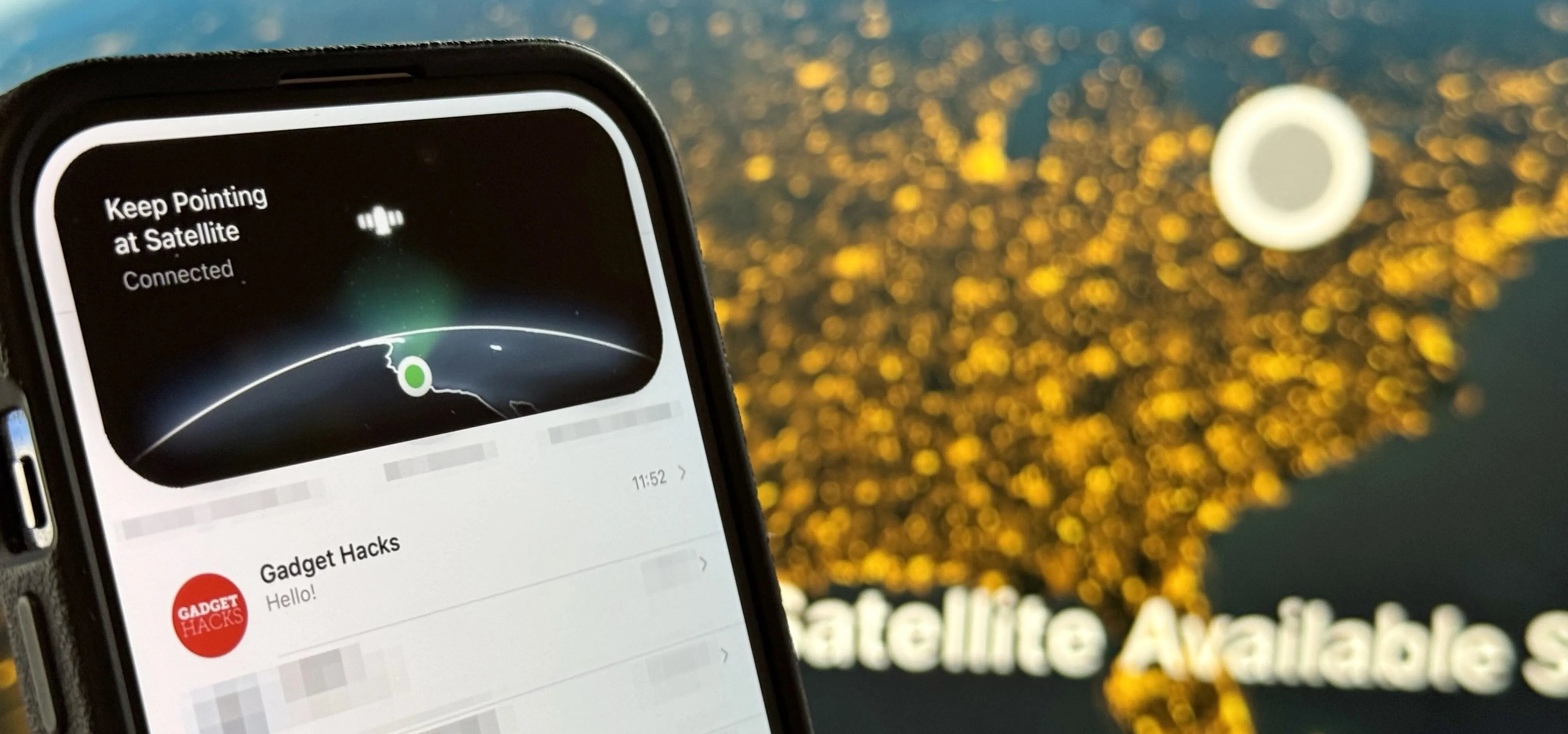 Smartphone displaying satellite connectivity information against a background of illuminated cityscape.