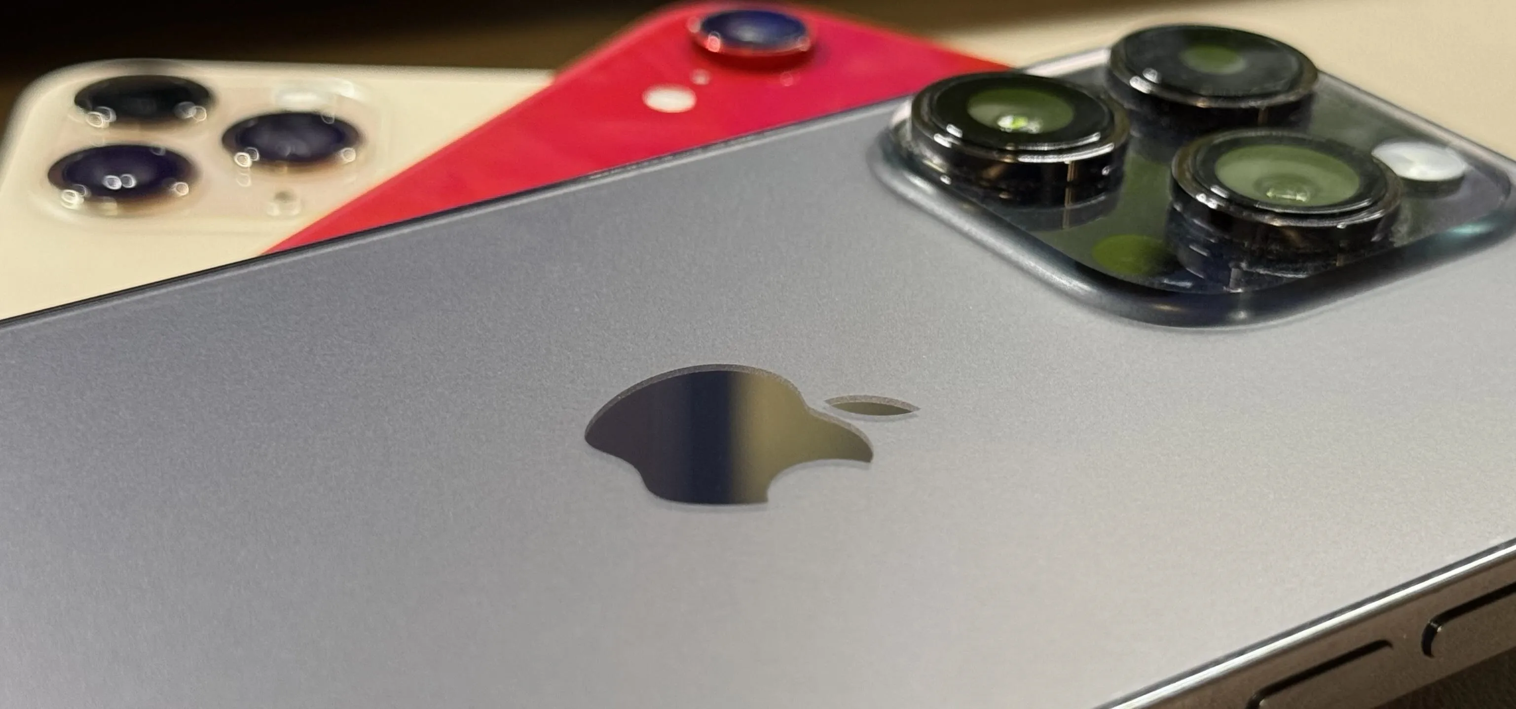 Apple smartphones showcasing camera details and logos.