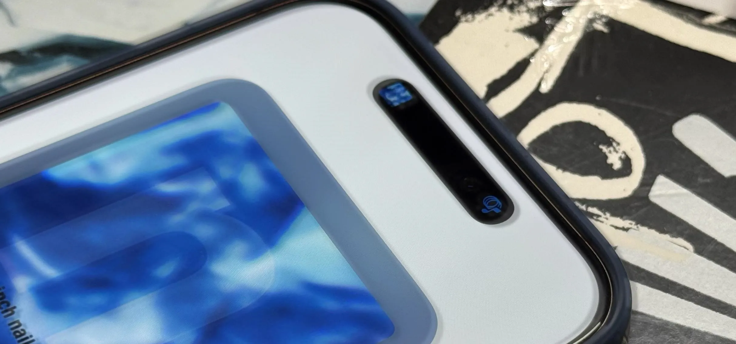 Close-up of a smartphone screen displaying a blue abstract image.