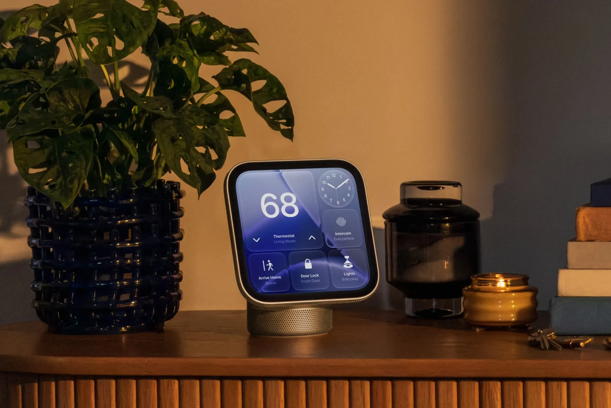 Apple HomeView apps and smart-home controls displayed on a tabletop screen showing thermostat settings, lighting, door locks, and intercom features.