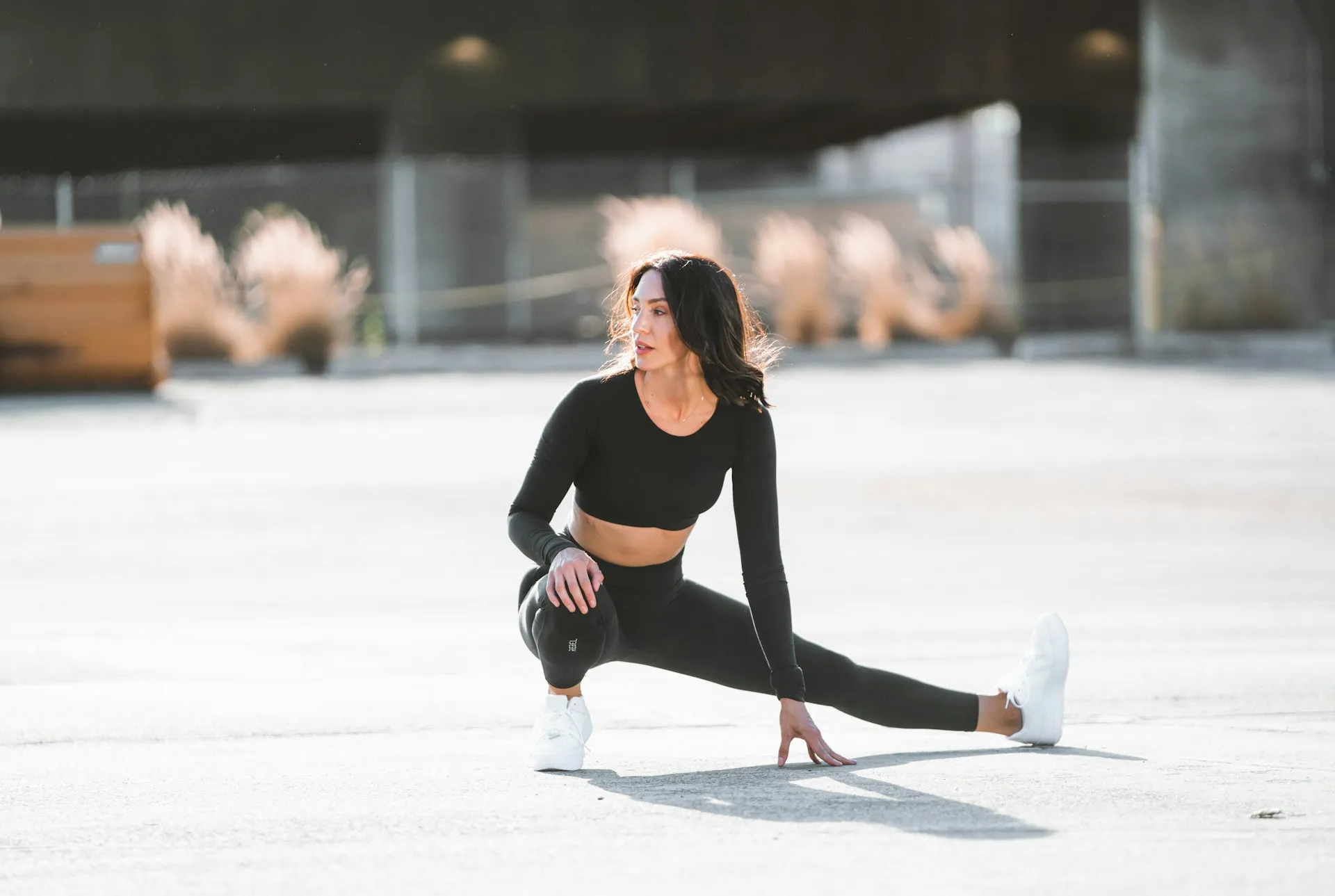 Image of a woman in fitness gear, stretching
