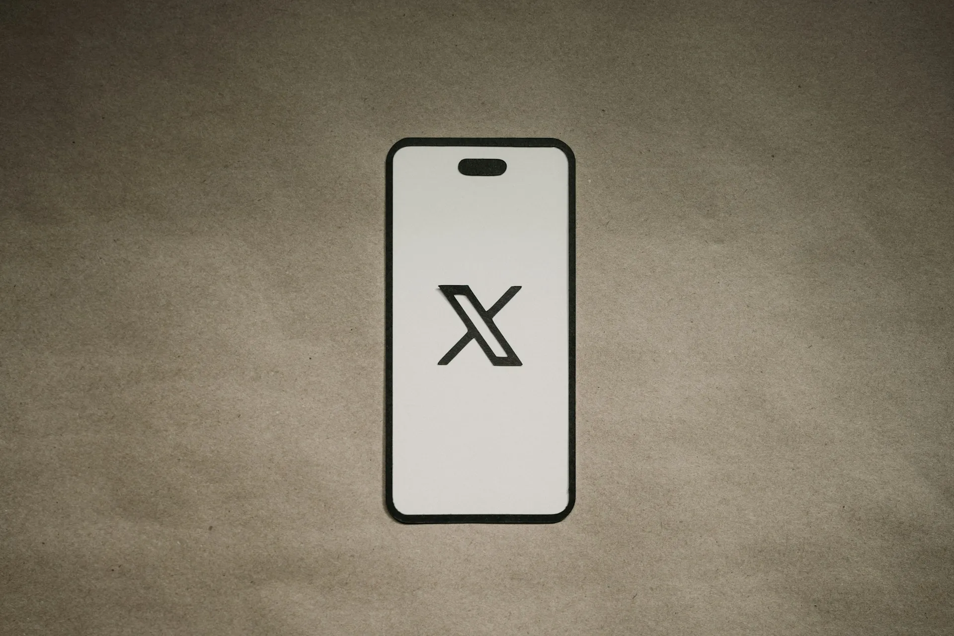 Image of a phone showing the X (formerly Twitter) logo