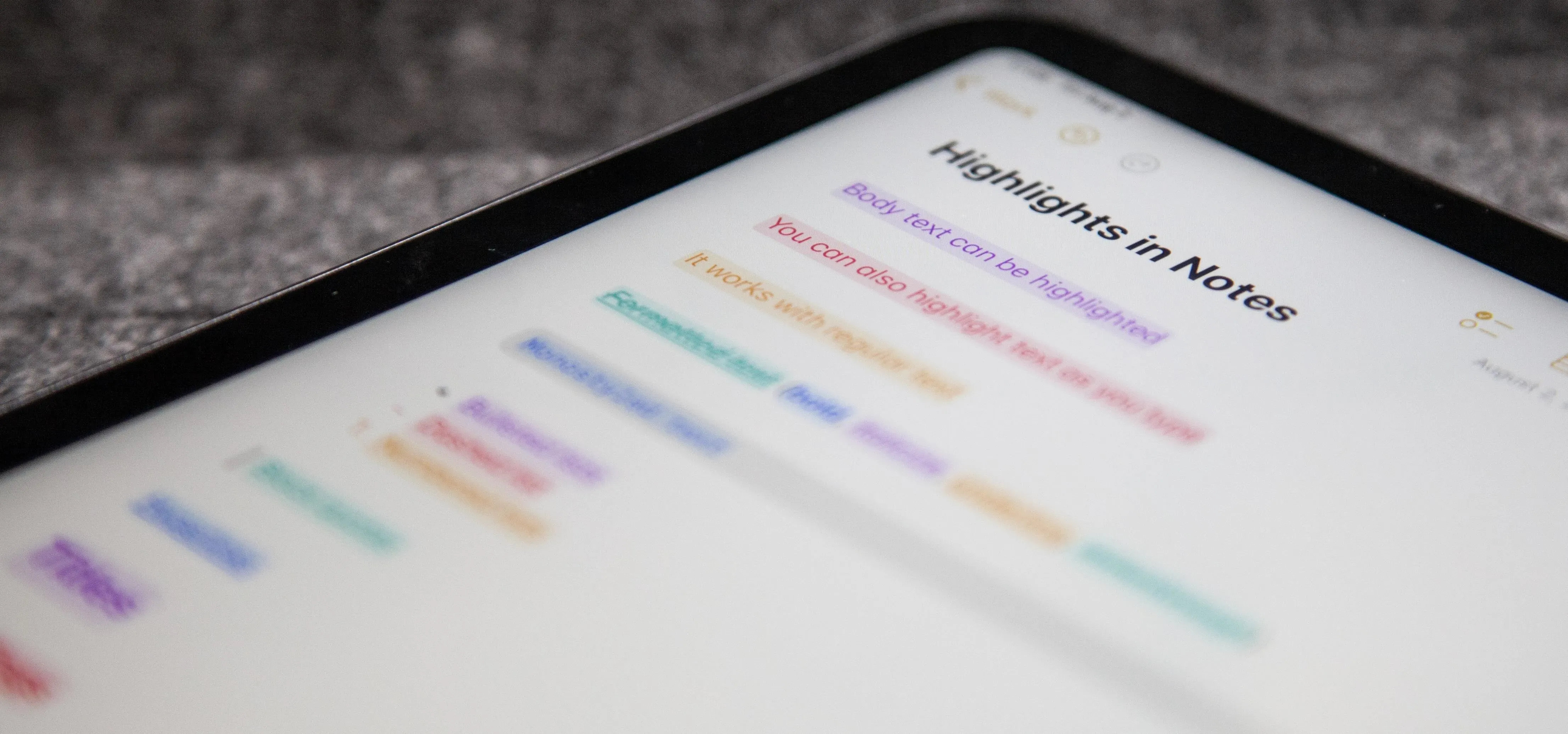 Close-up of a digital note-taking application on an iPad screen with highlighted text in different colors.